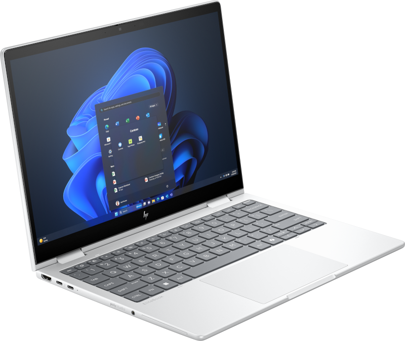 Silberner Laptop mit geöffnetem Menü, blauem Hintergrundbild und Tastatur.