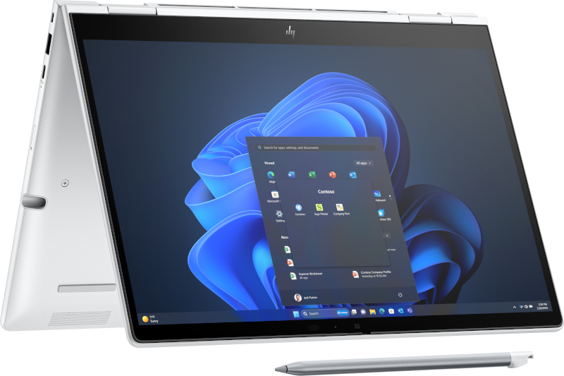 Ein silberner Laptop mit geöffnetem Bildschirm, der das Windows 11-Startmenü zeigt.