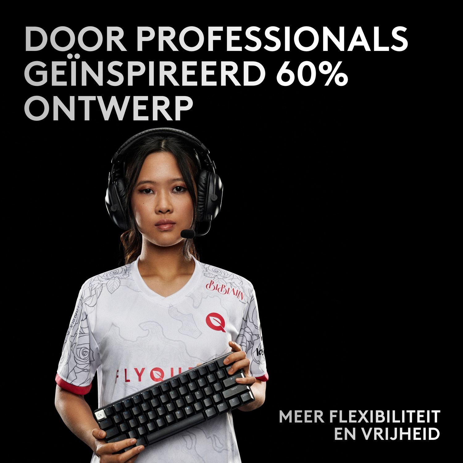 A woman wearing headphones and a t-shirt holds a keyboard.