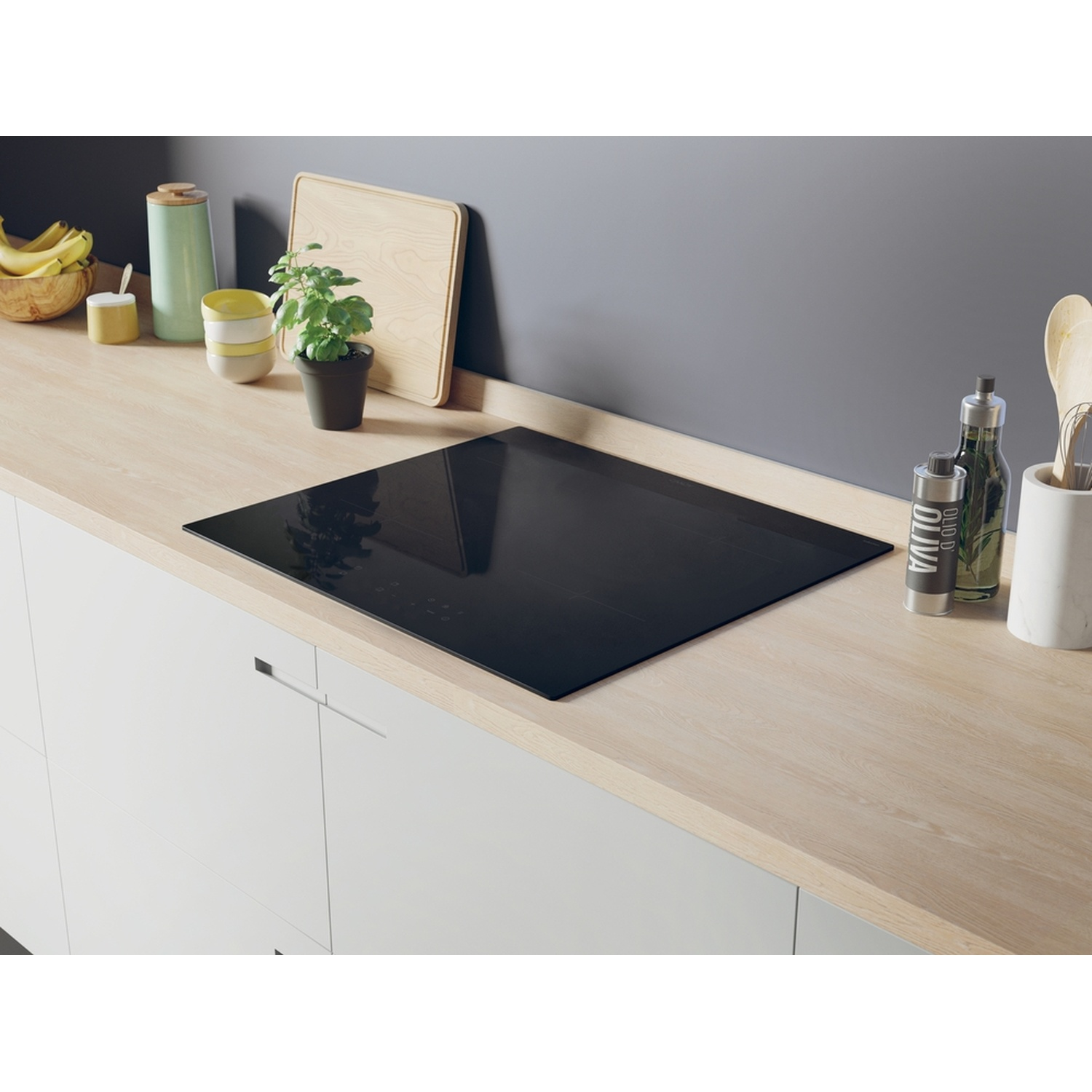 Cucina moderna con piano cottura nero, piano di lavoro in legno e frutta.