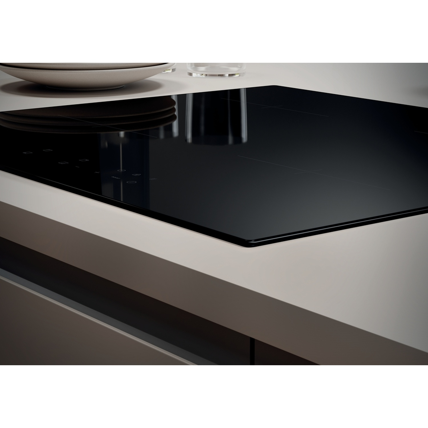 Un'elegante piastra a induzione nera con comandi touch e piatti sullo sfondo.