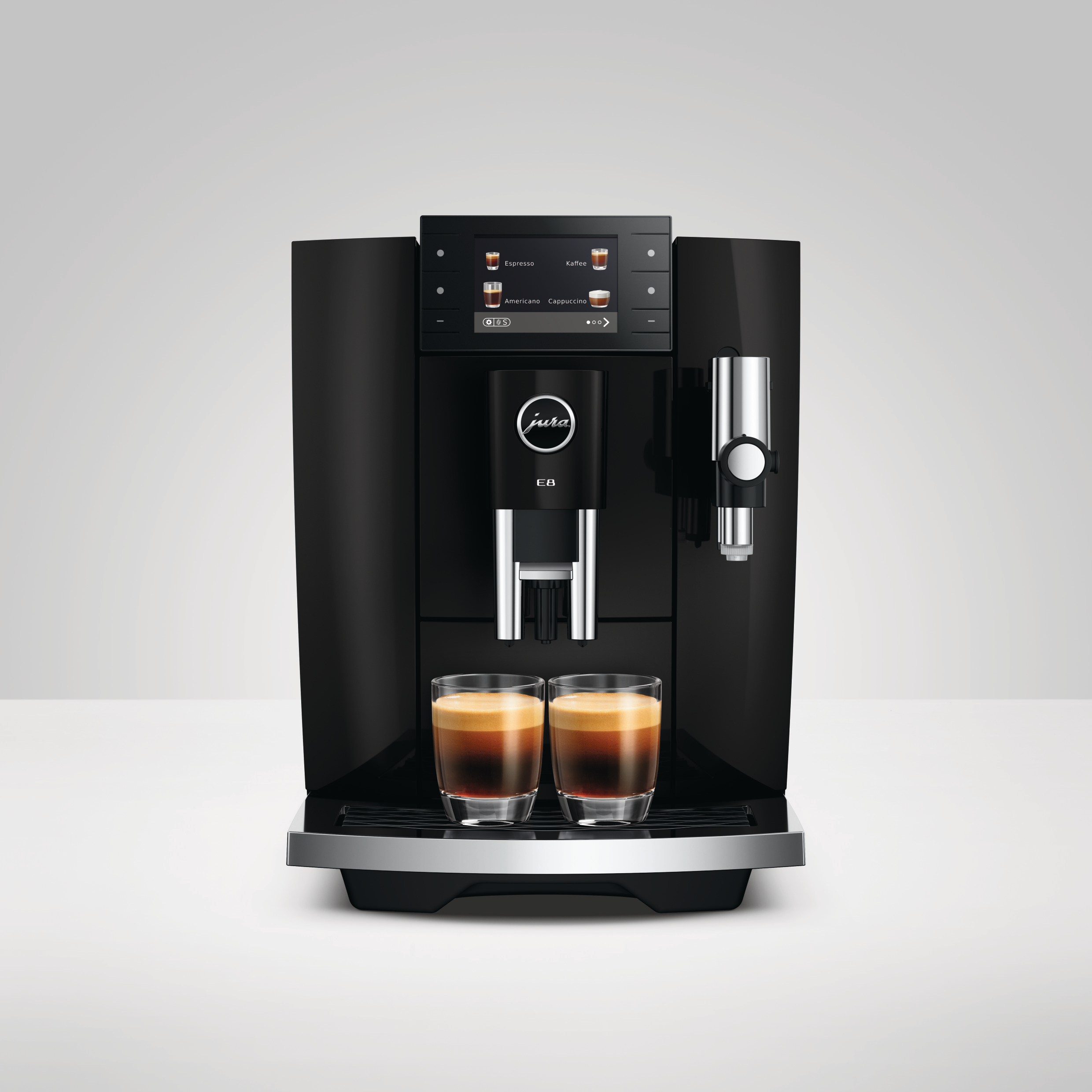 Schwarze Kaffeemaschine mit zwei Gläsern Espresso und einem Touchscreen-Display.