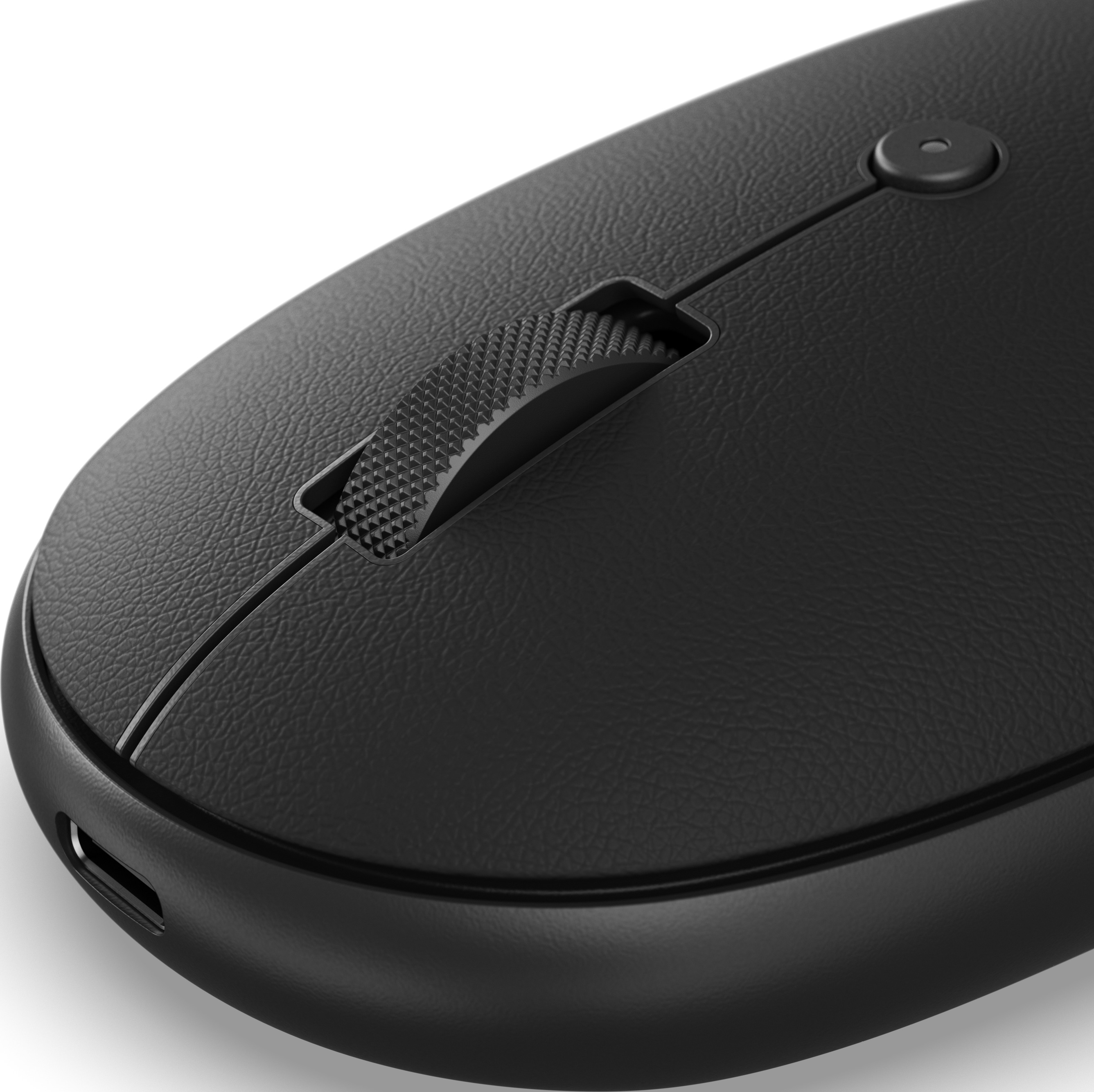 Primo piano di un mouse per computer nero, con rotellina e pulsante testurizzati.