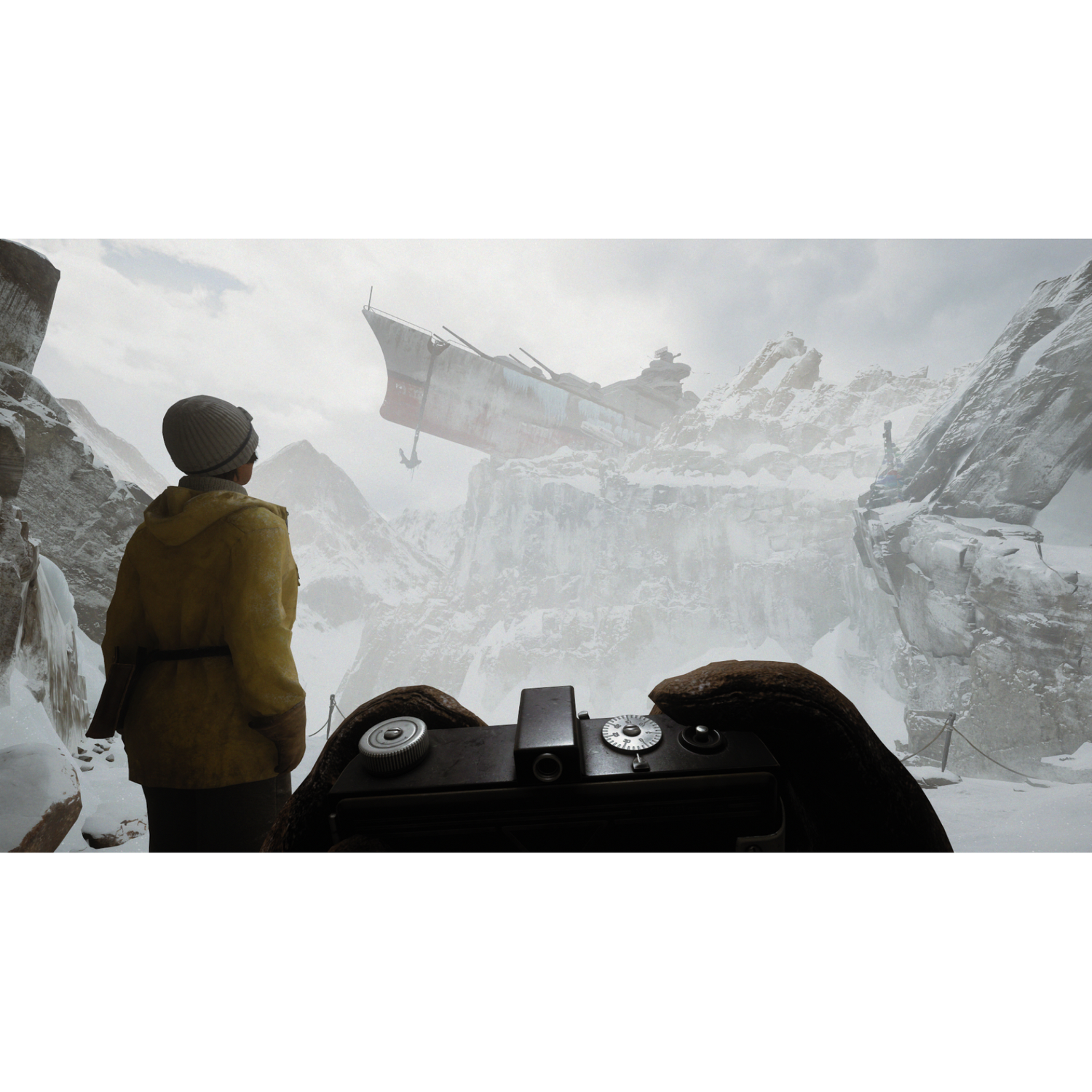 A person in a yellow jacket looks at a stranded ship in snowy mountains.
