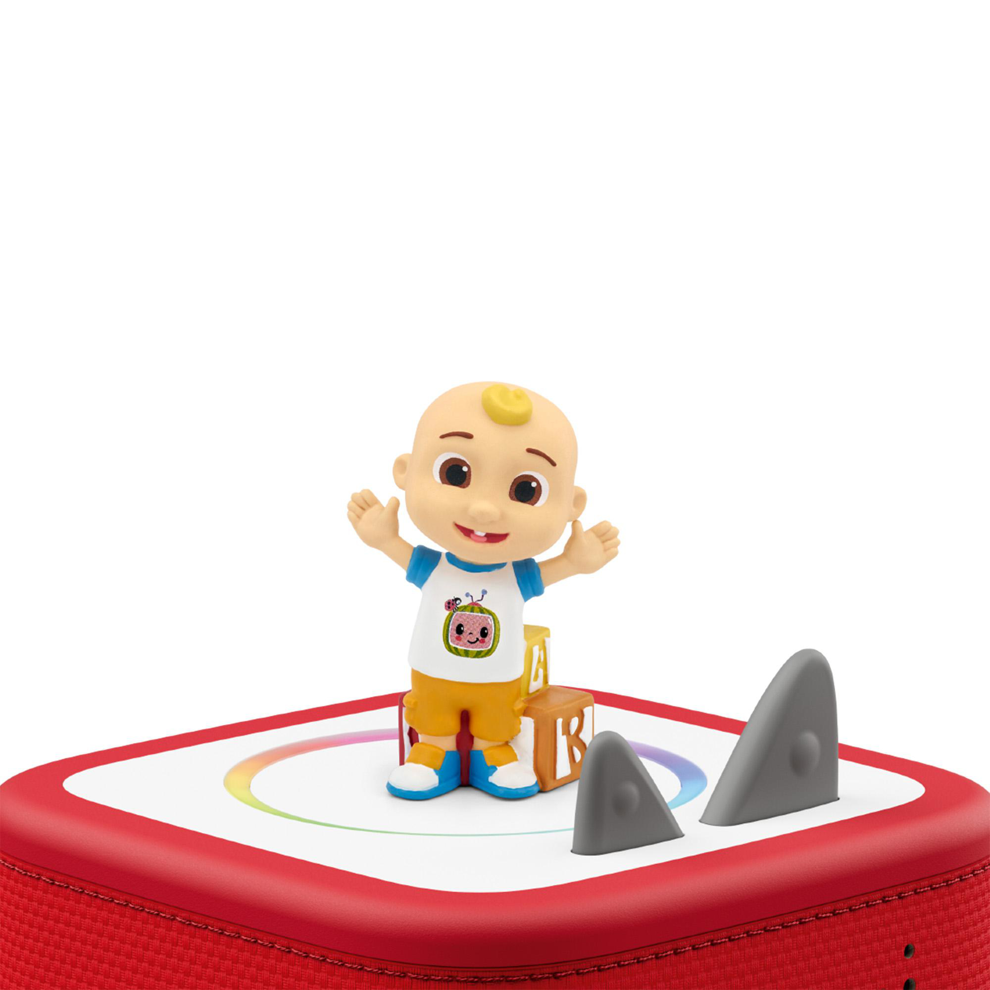 Babyfigur auf rotem Spielzeug mit bunten Lichtern und Haifischflossen.