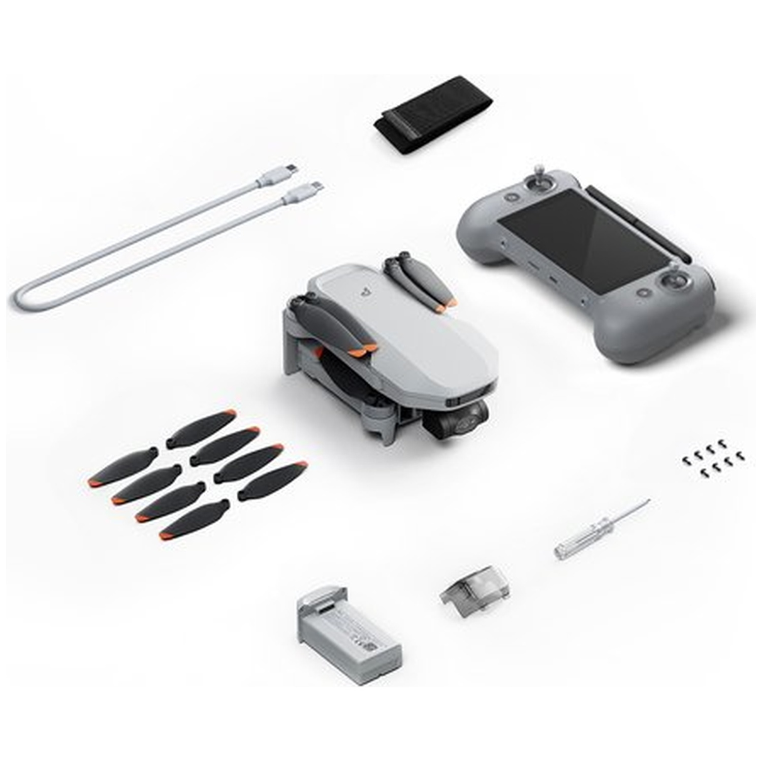 Drone met accessoires: afstandsbediening, batterij, propellers, kabels, schroevendraaier.