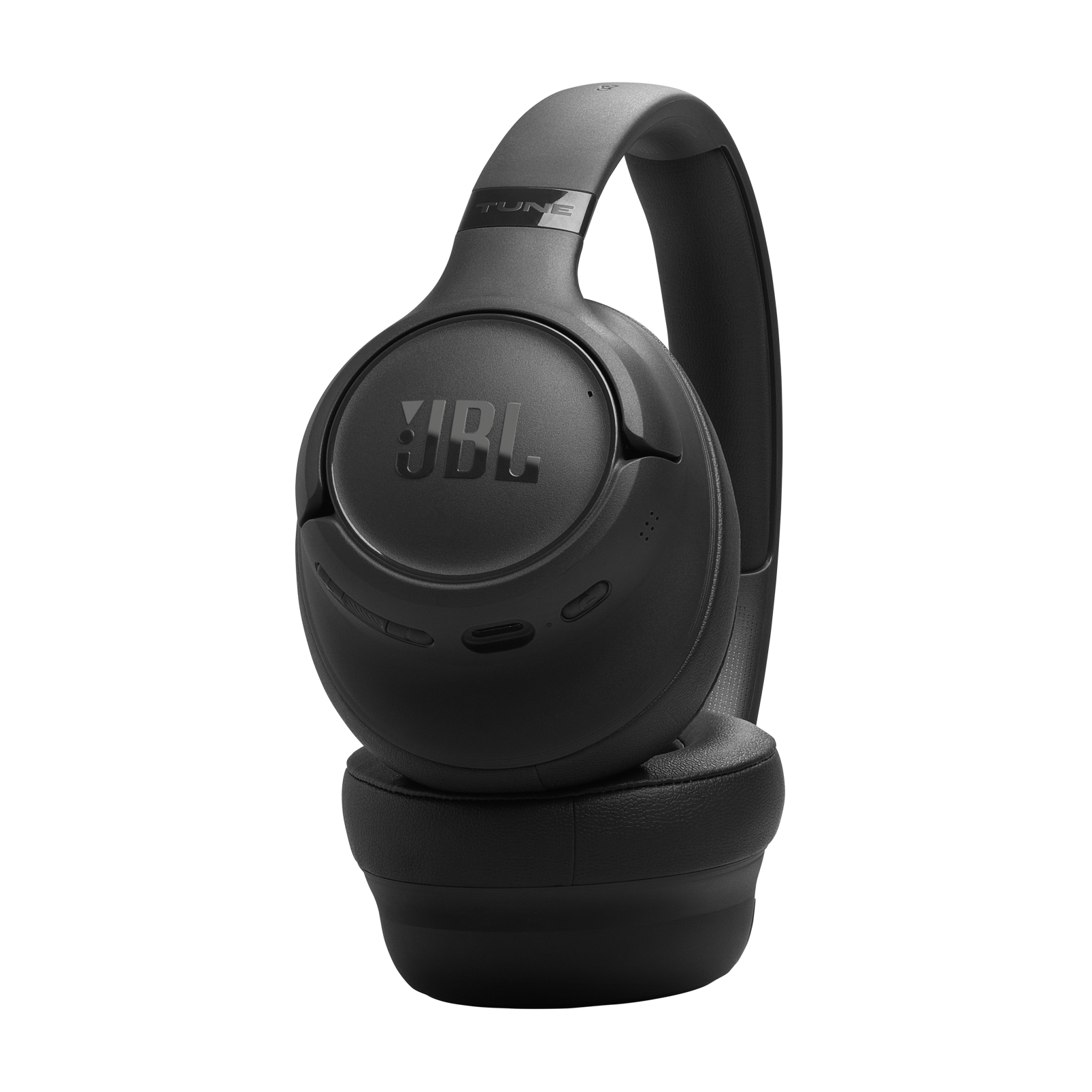 Auriculares JBL negros con orejeras y diadema, sobre fondo negro.