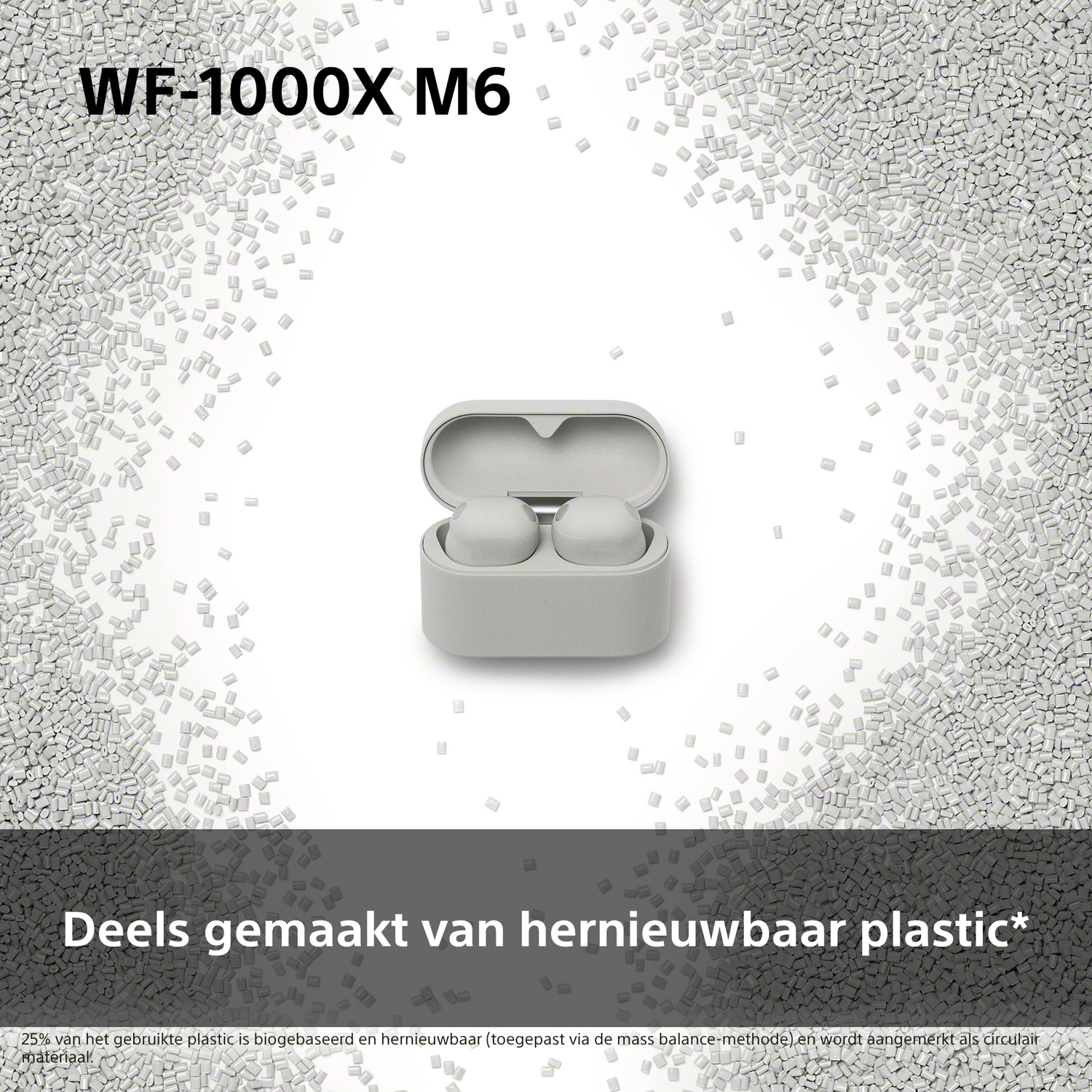 Gray earbuds with charging case, surrounded by small plastic pellets.