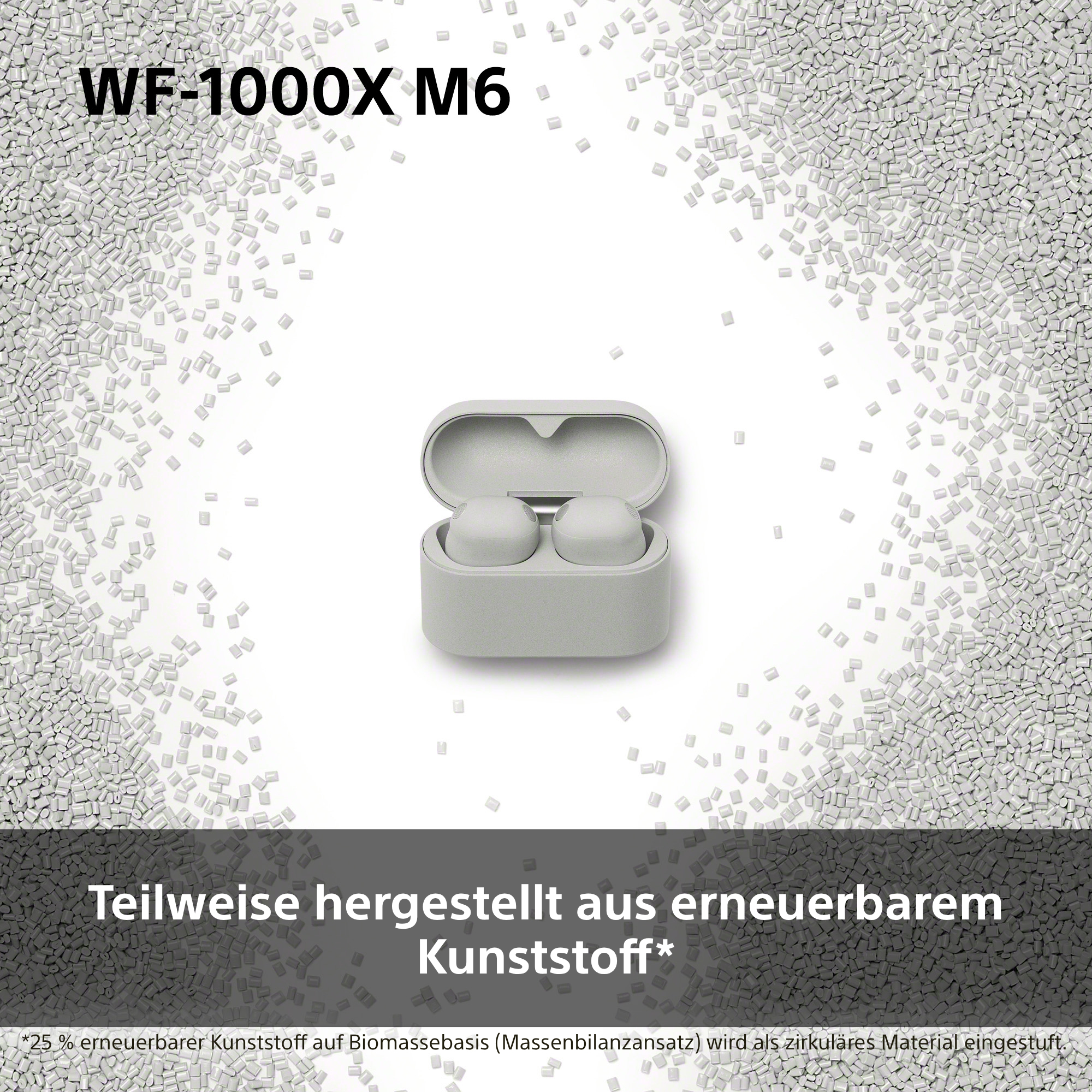 Graue kabellose Kopfhörer in einem grauen Ladeetui, umgeben von kleinen grauen Kunststoffpellets.