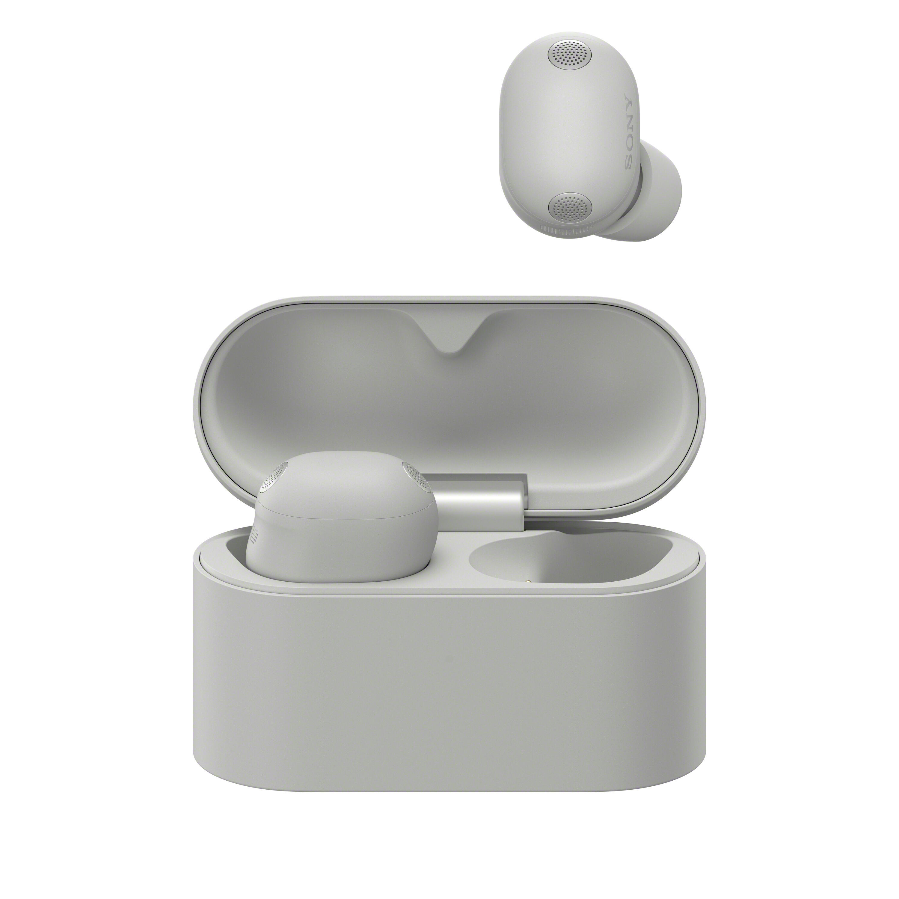 Un par de auriculares Sony grises con estuche de carga abierto, un auricular está arriba.