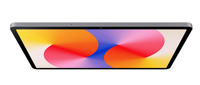 Szary tablet z abstrakcyjnym kolorowym tłem. Widok z bliska.