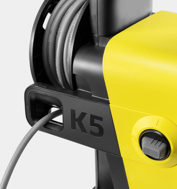 Żółta myjka ciśnieniowa z czarnym bębnem na wąż i napisem "K5".