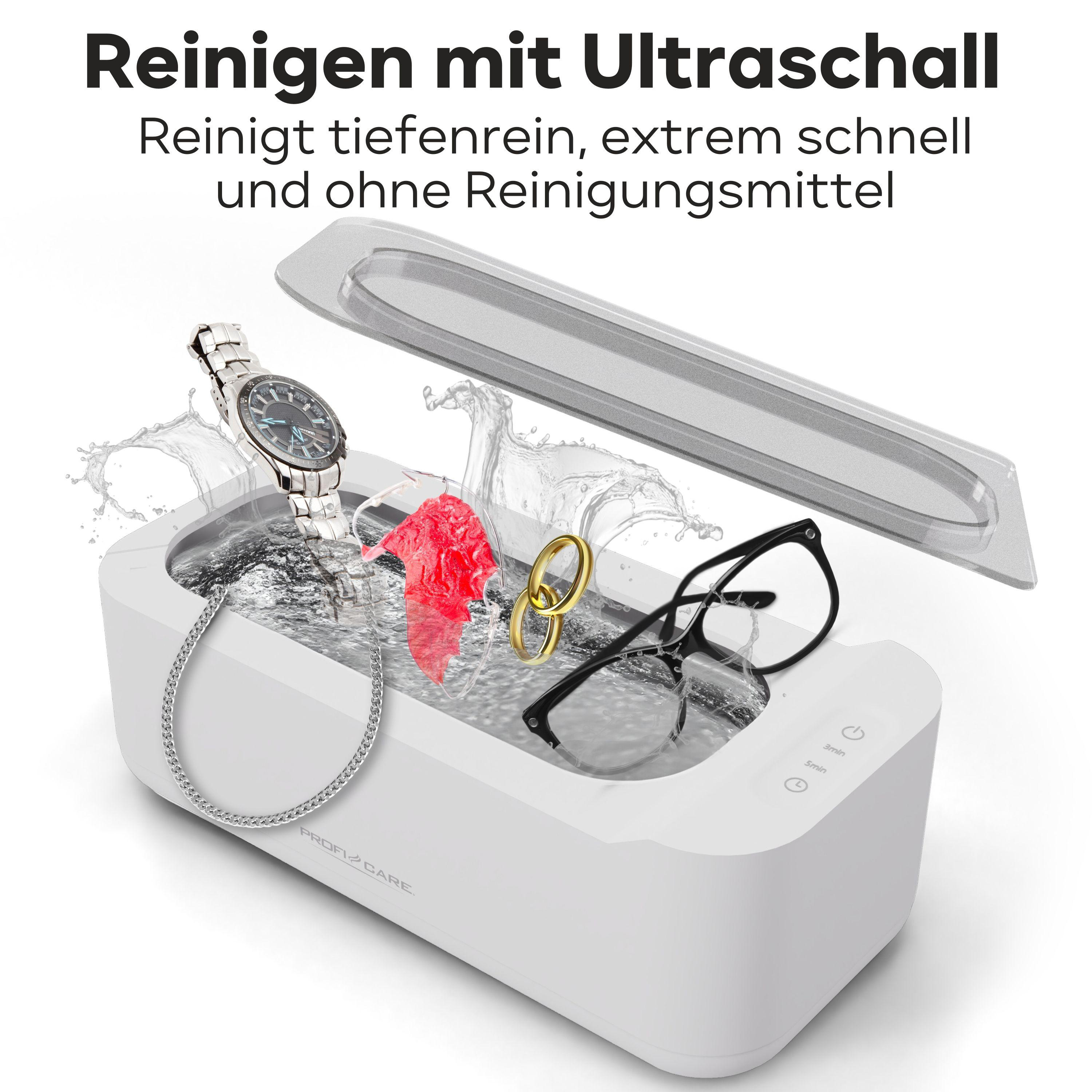 Ultraschallreiniger mit Uhr, Brille und Ringen in Wasser.
