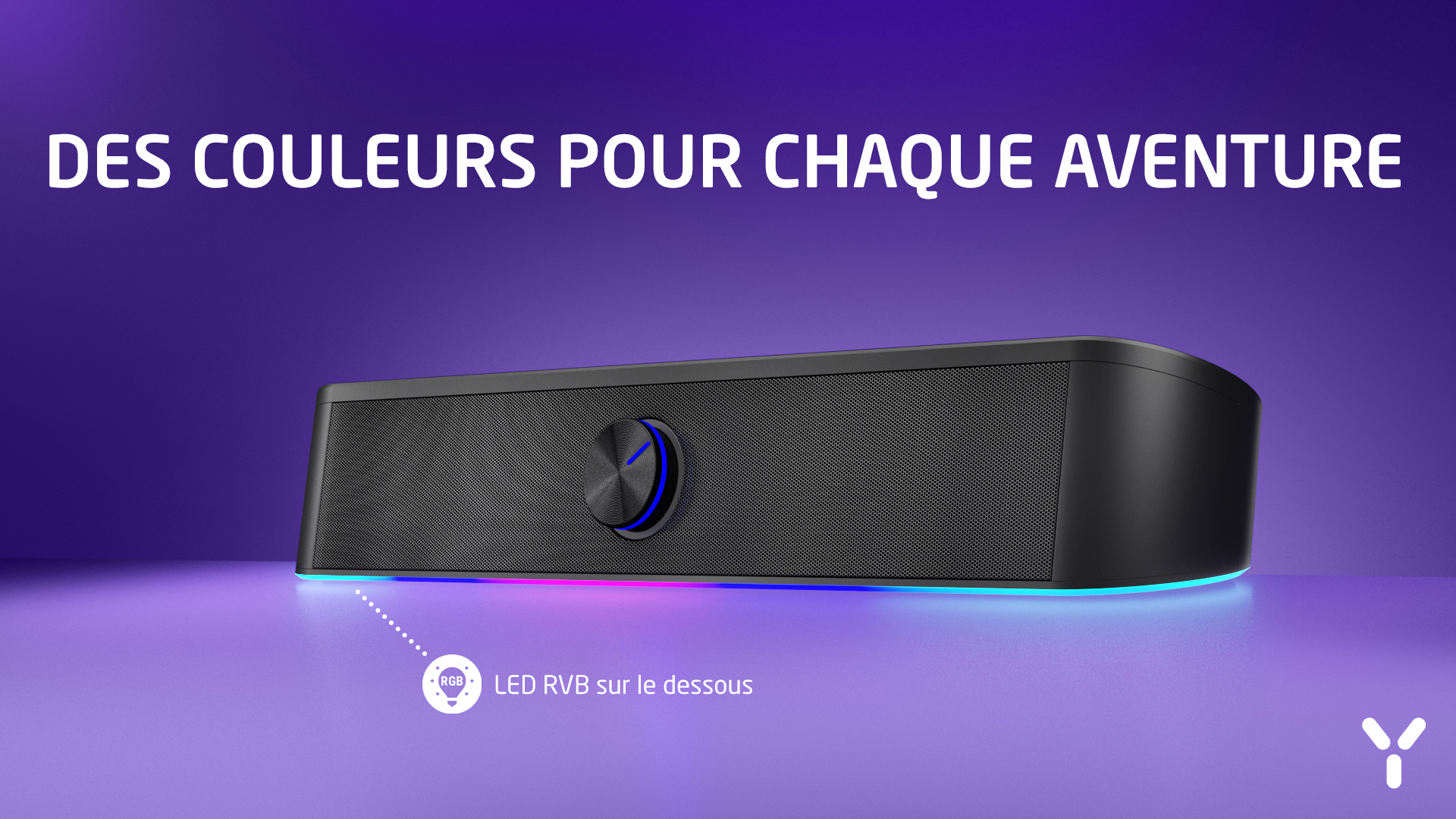 Czarny głośnik z diodami RGB i pokrętłem na fioletowym tle.