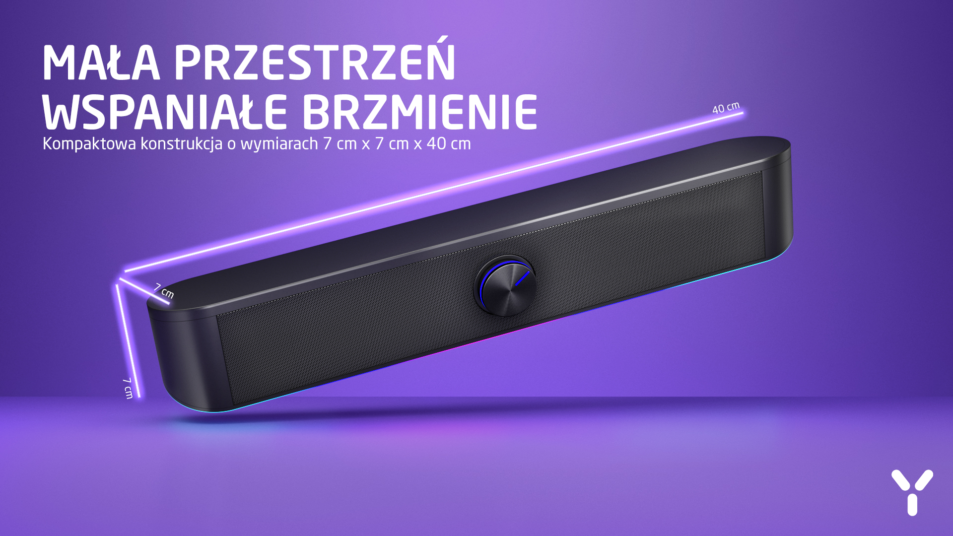 Czarny kompaktowy głośnik z niebieskim pokrętłem na fioletowym tle.