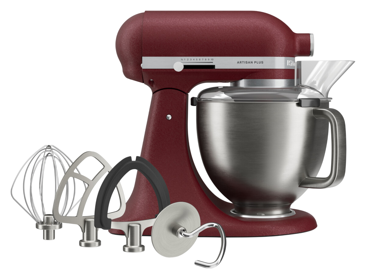 Eine dunkelrote KitchenAid Artisan Plus Küchenmaschine mit Edelstahlschüssel, klarem Spritzschutz und vier Aufsätzen.
