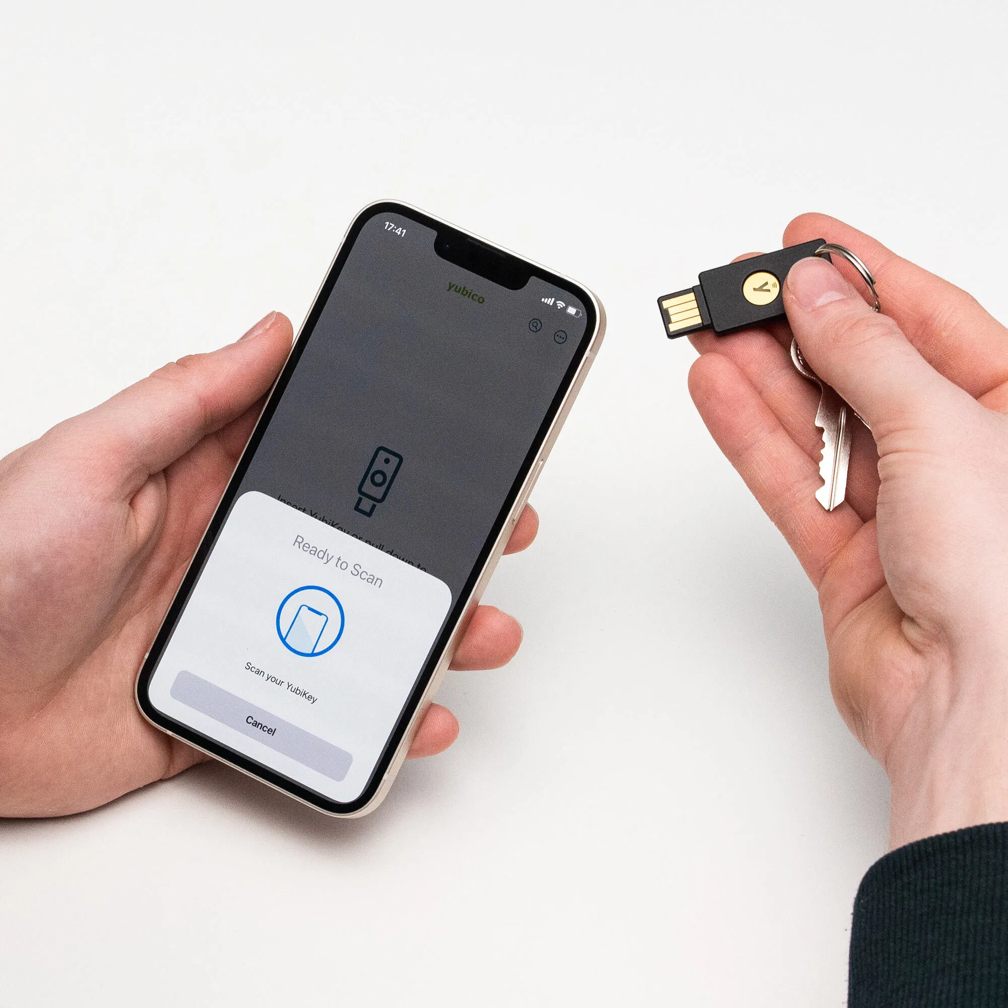 Hände halten ein Smartphone mit „Ready to Scan“ und einen YubiKey.