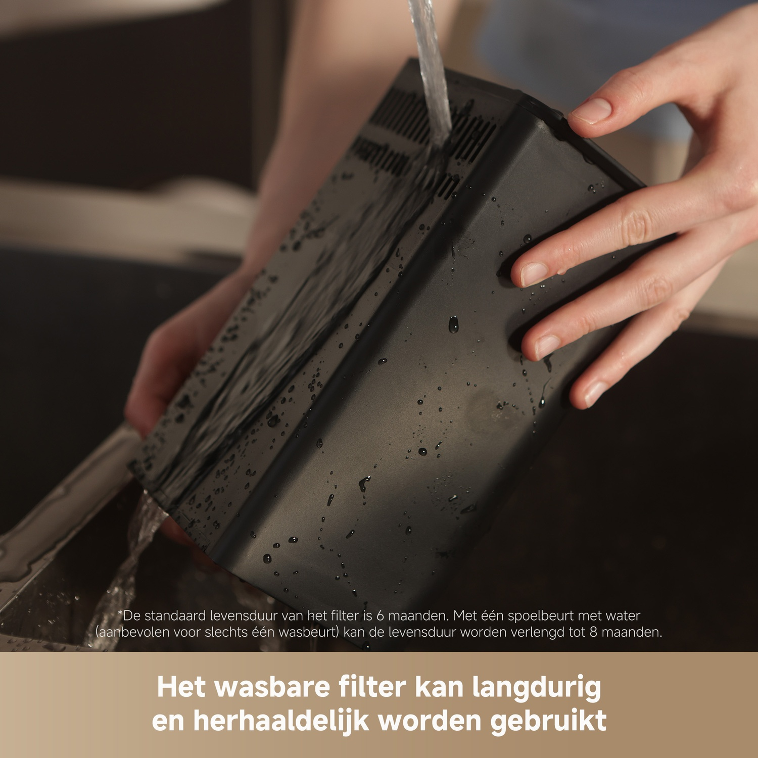 A hand rinses a black filter under running water in a sink.