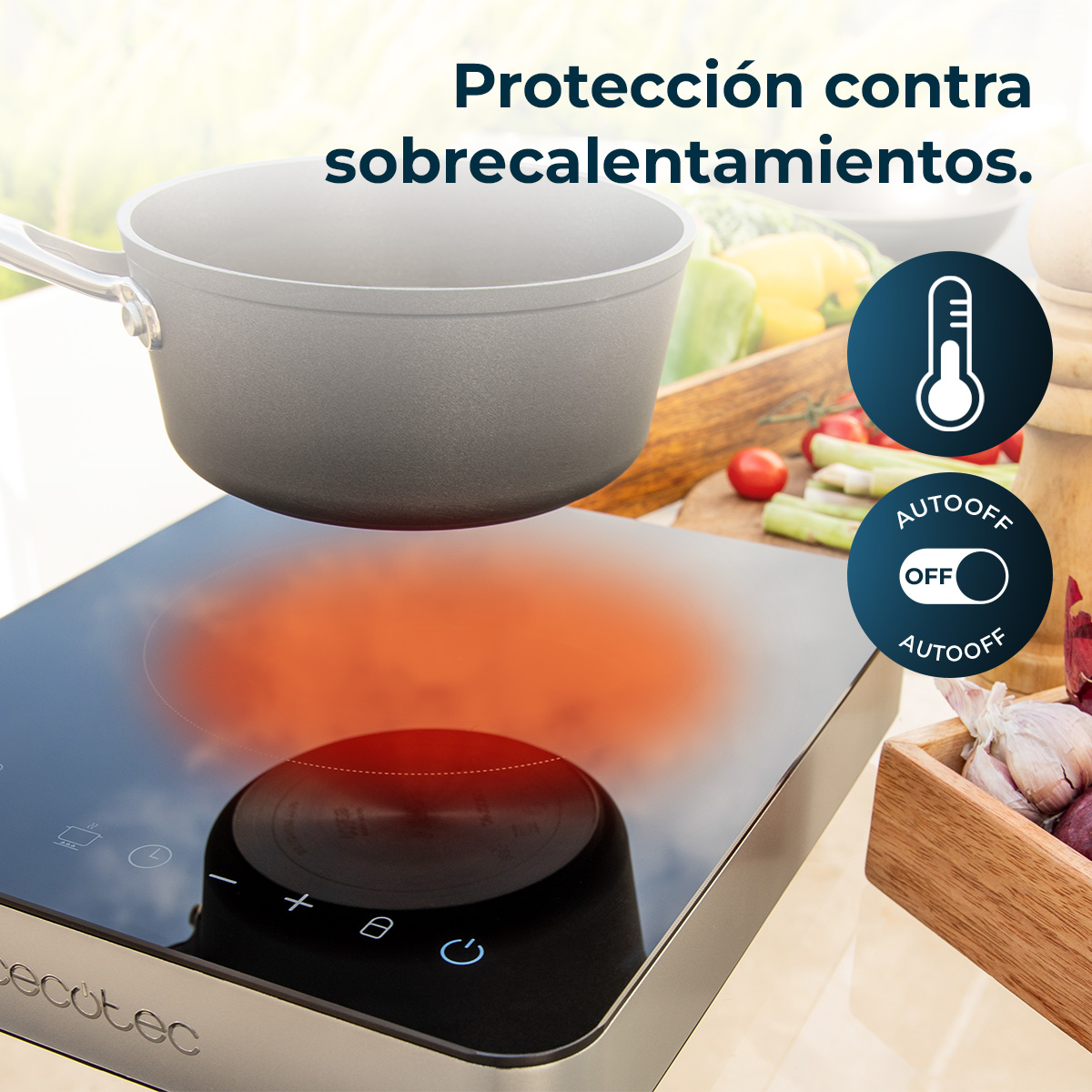 Vitrocerámica de inducción con olla, mostrando iconos de protección contra sobrecalentamiento y verduras.