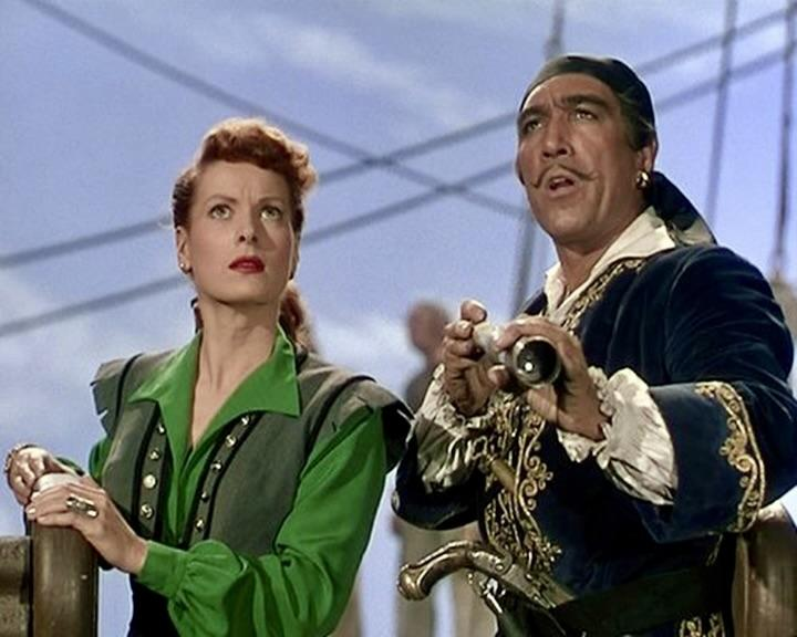 Ein Mann mit Schnurrbart, der ein Fernglas hält, und eine Frau mit roten Haaren auf einem Schiff.