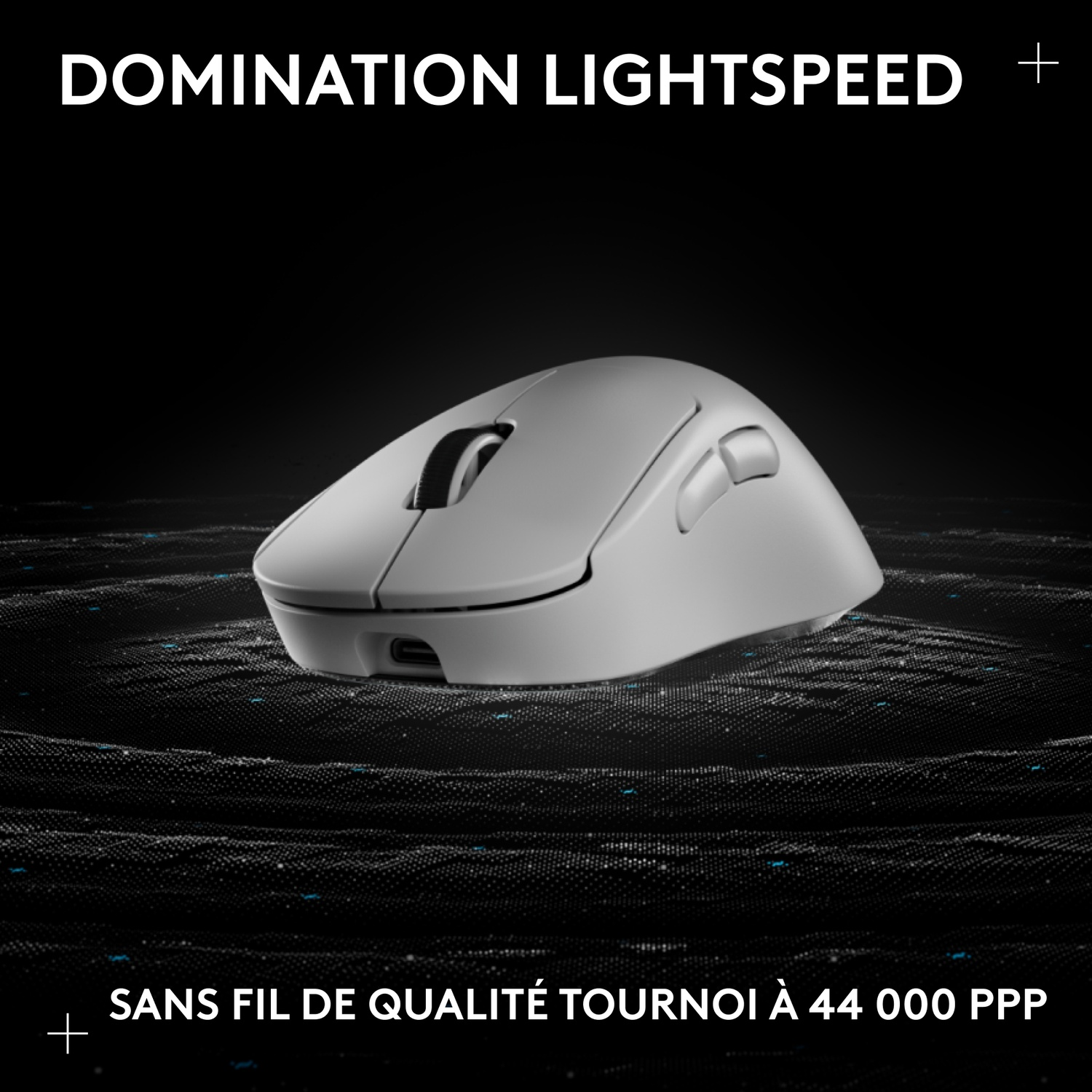 Une souris sans fil grise repose sur un fond sombre et texturé.