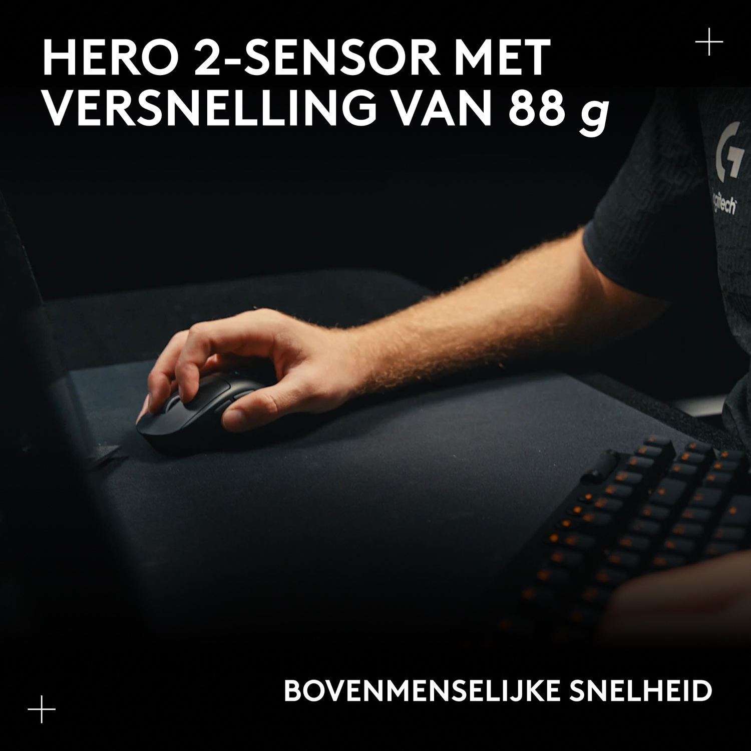 A hand uses a black mouse on a mousepad next to a keyboard.