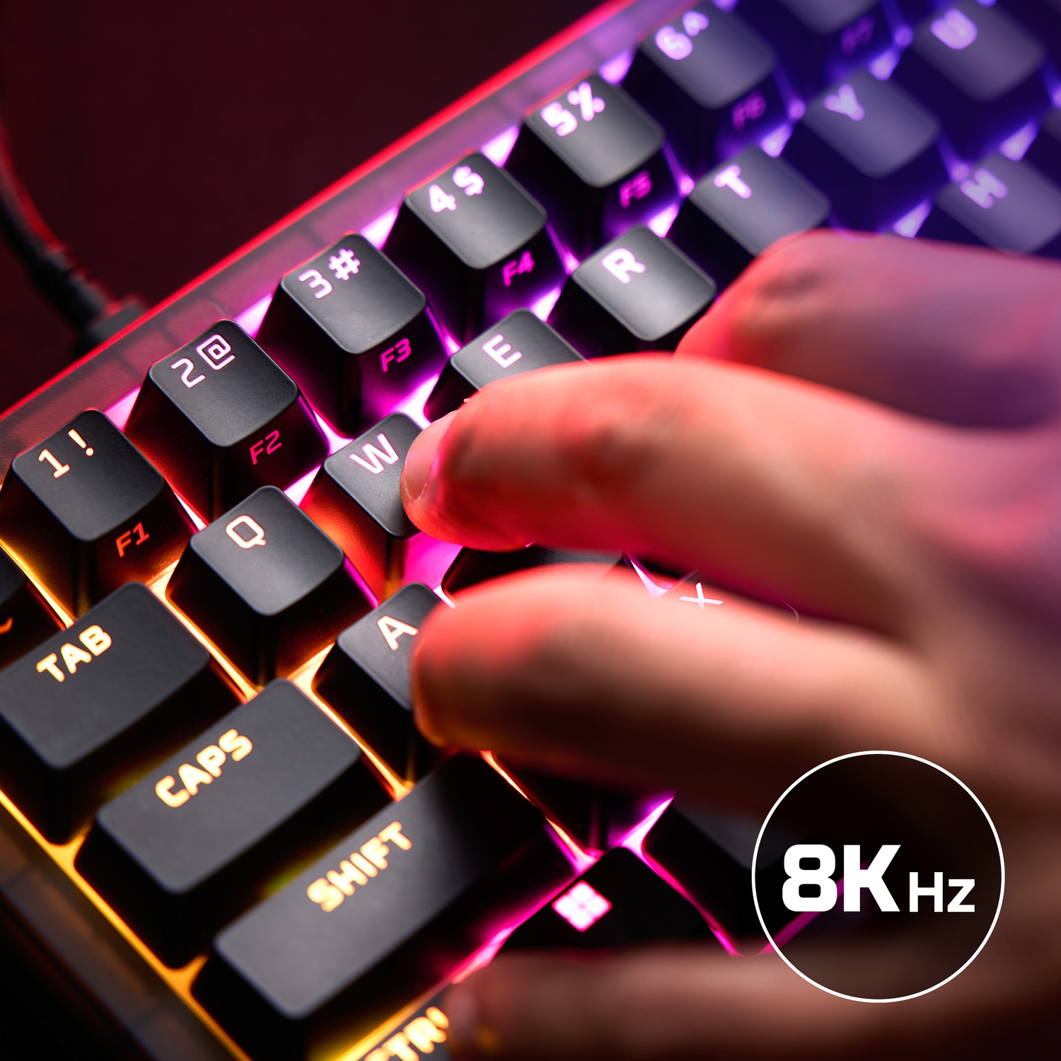 Close-up of a person typing on an RGB illuminated keyboard. 8KHz logo.