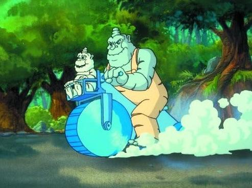 Zwei grüne Wesen fahren auf einem blauen Einrad durch einen Wald.