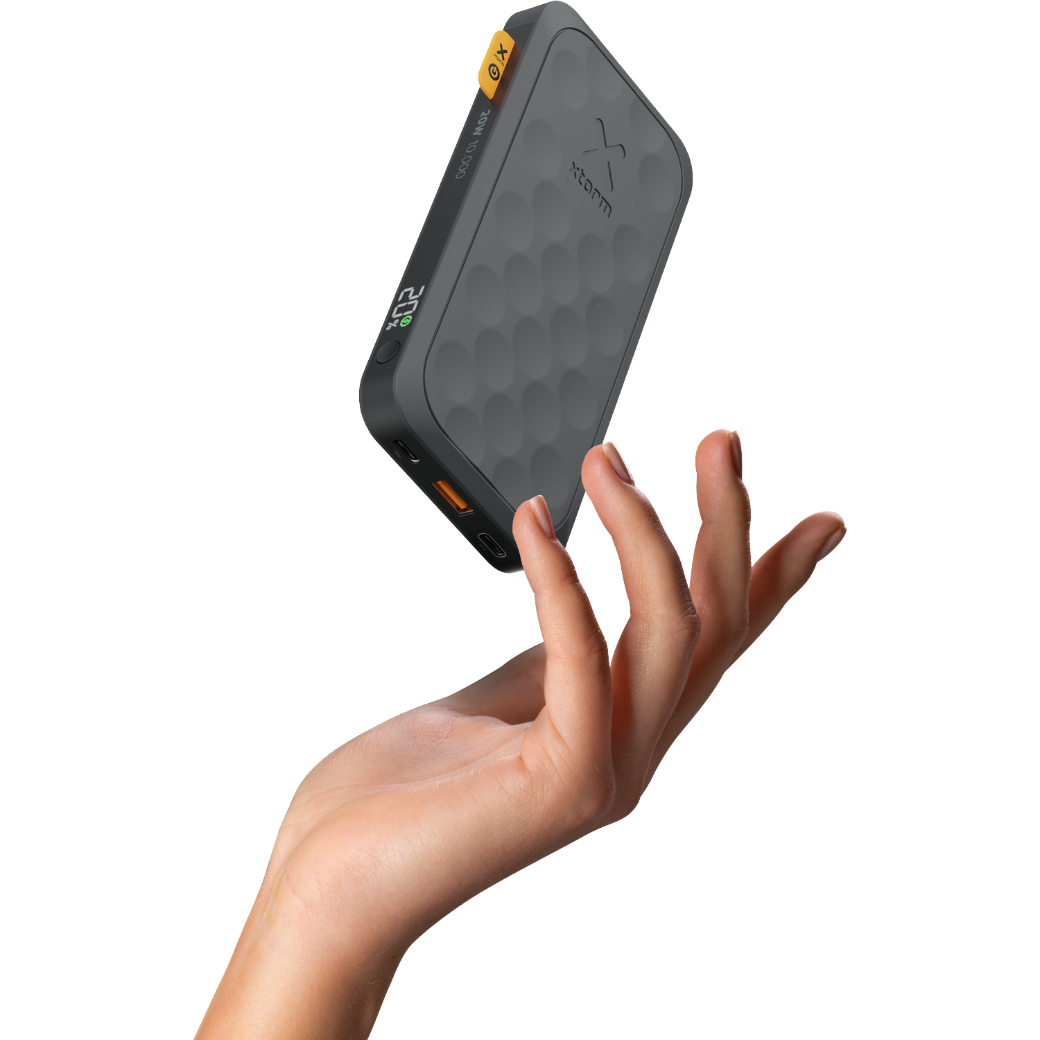 A hand holds a gray power bank with a honeycomb pattern and a yellow accent.