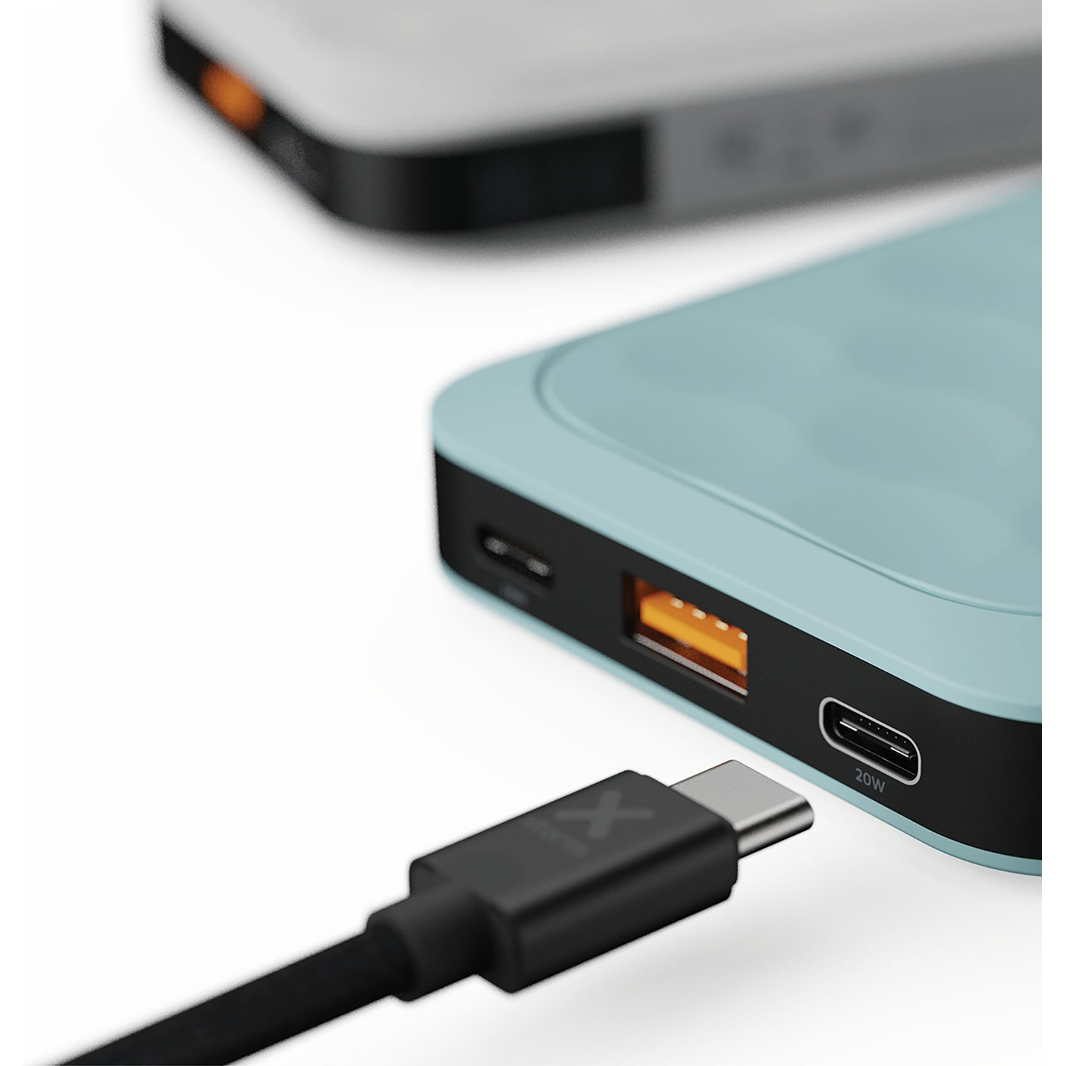 A black USB-C cable plugs into a light blue power bank with a 20W port.