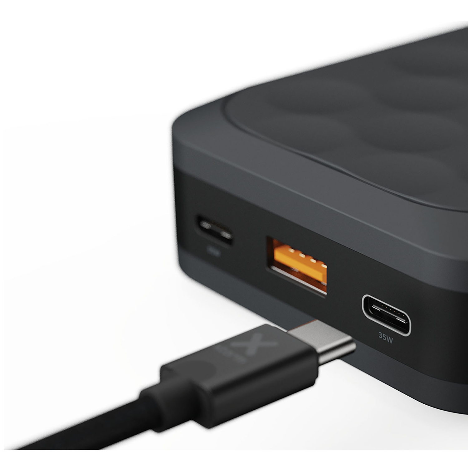 A black USB-C cable is plugged into a power bank device.