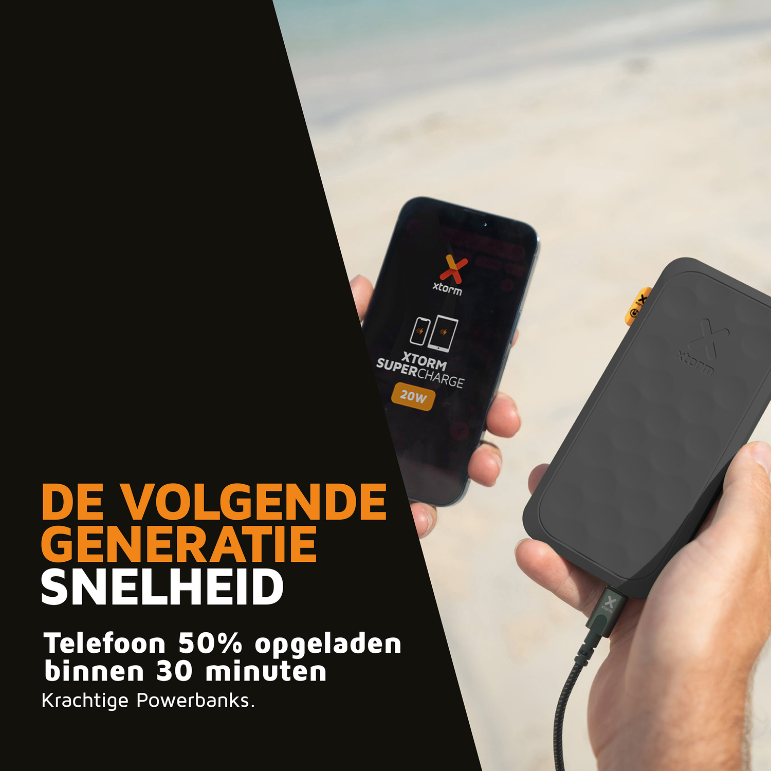 Person charging a smartphone with an Xtorm power bank on a beach.
