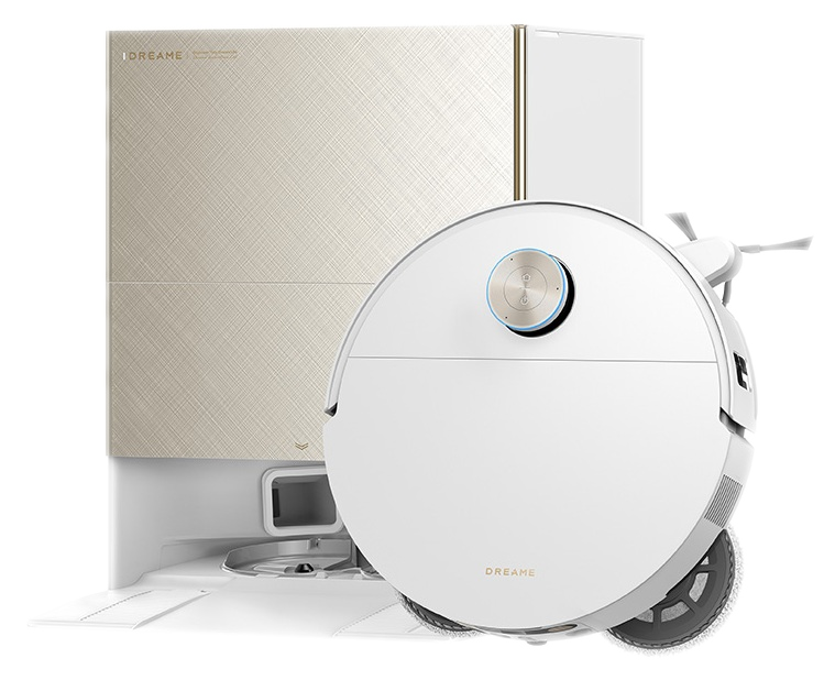 Biały robot sprzątający stoi obok beżowej stacji ładującej o teksturowanej powierzchni.