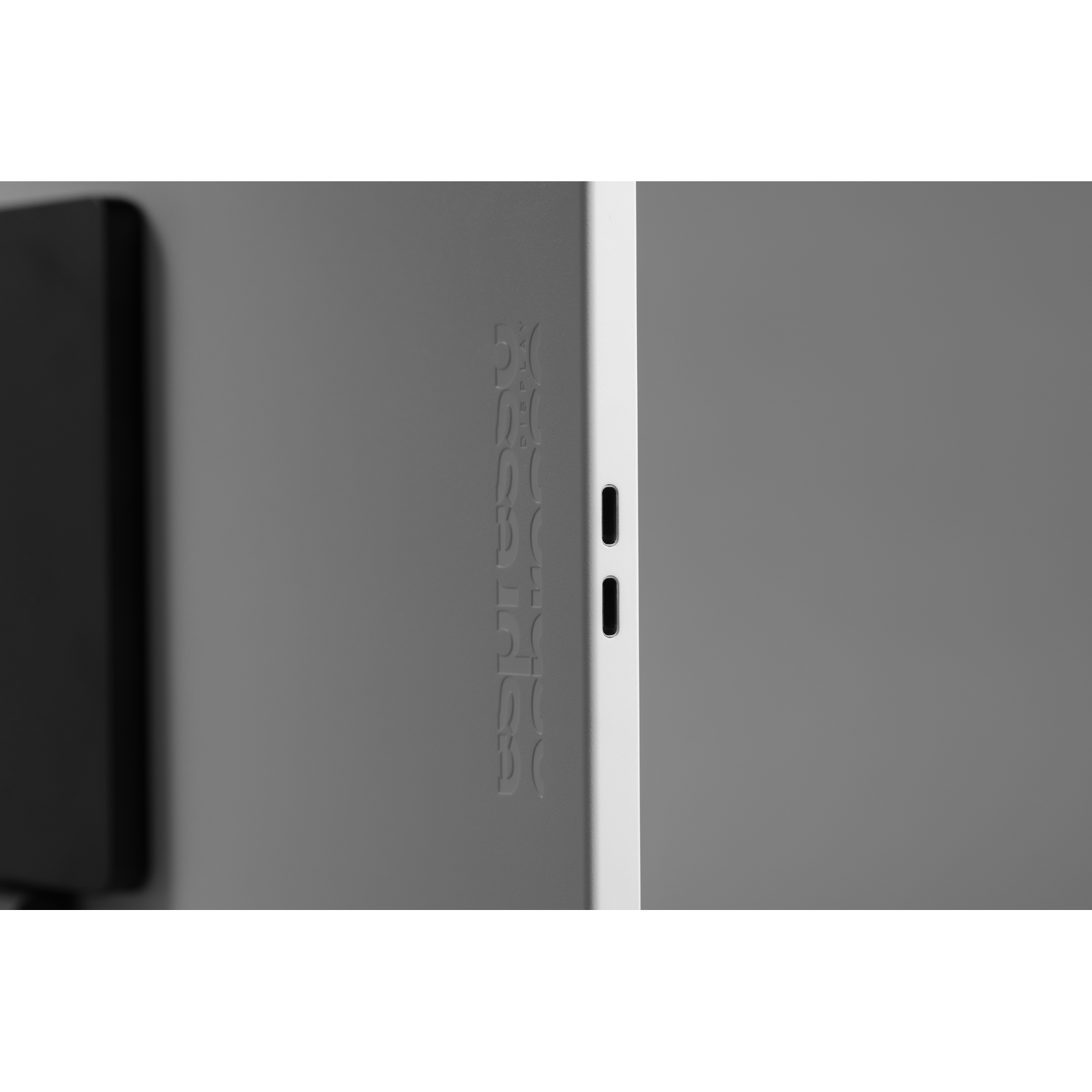 Gray tablet with engraved logo and two charging ports.