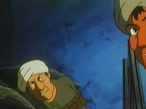 Ein Mann mit weißem Turban liegt gefesselt, ein anderer Mann mit orangefarbenem Gesicht blickt herab.