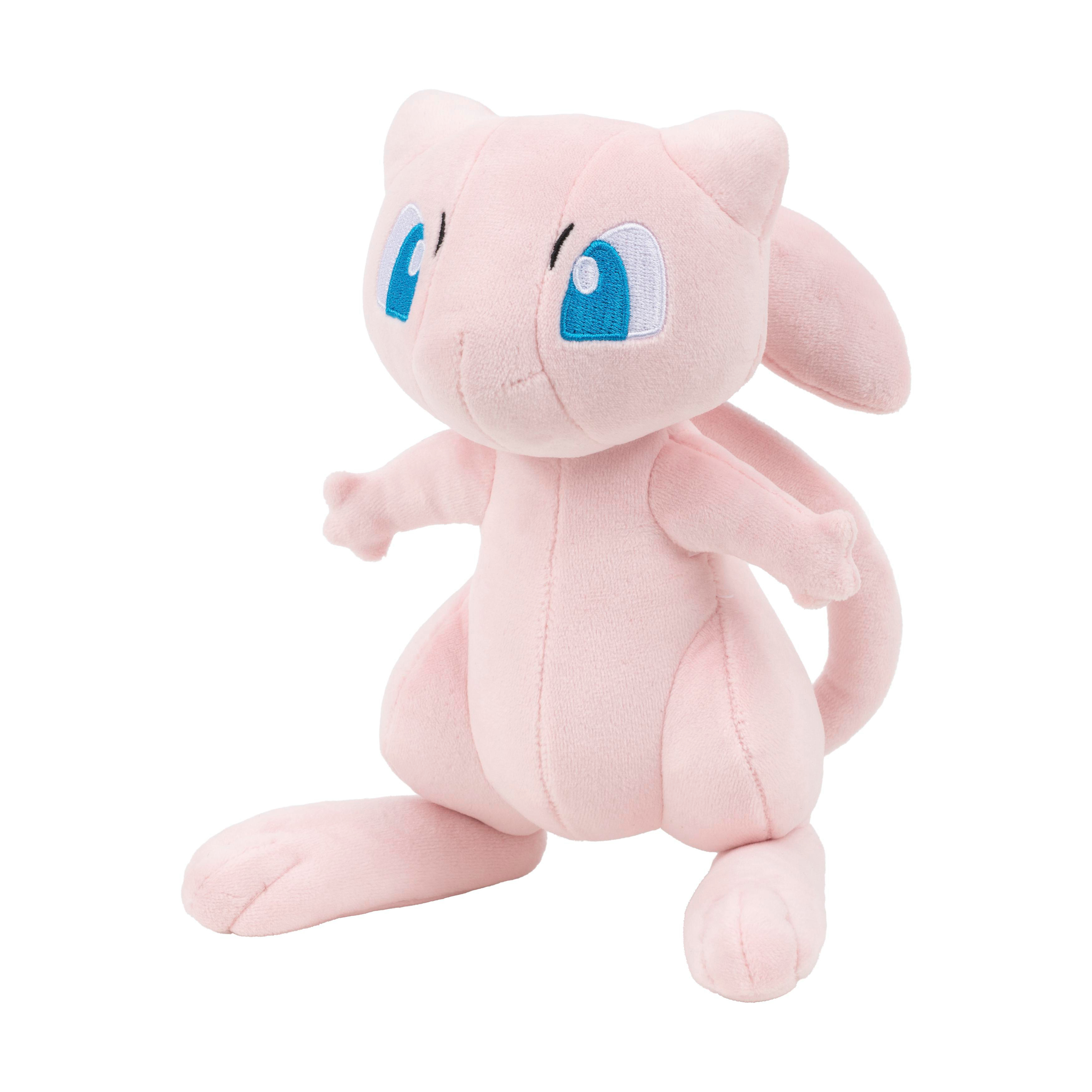 Ein rosafarbener Mew-Plüsch mit blauen Augen sitzt auf einem weißen Hintergrund.