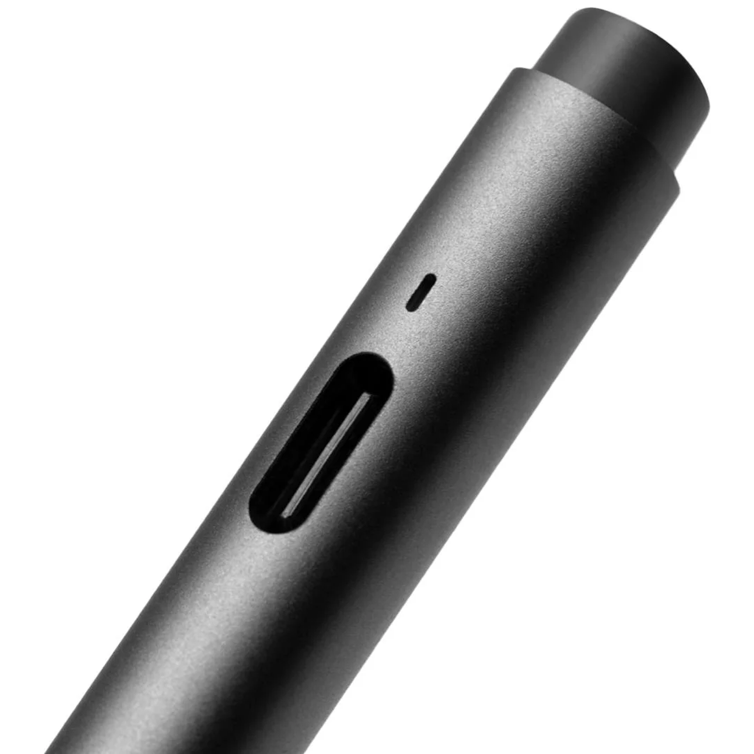 Close-up of a dark, cylindrical object with a slot and a dot.