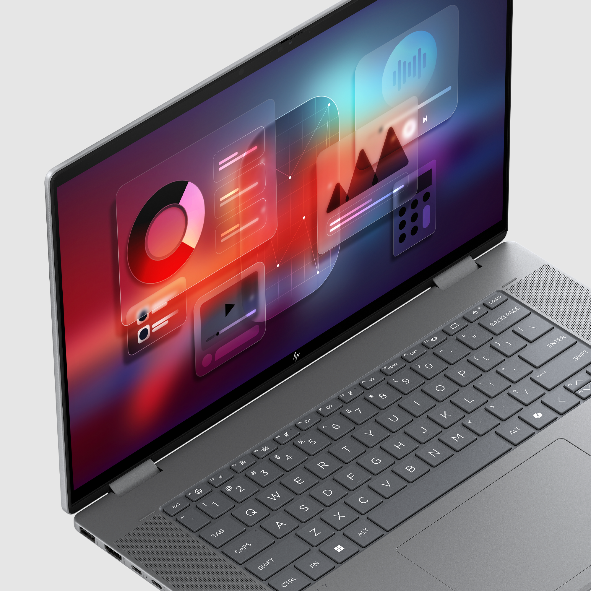 Szary laptop z kolorowym interfejsem pokazującym wykresy i elementy odtwarzacza muzyki.