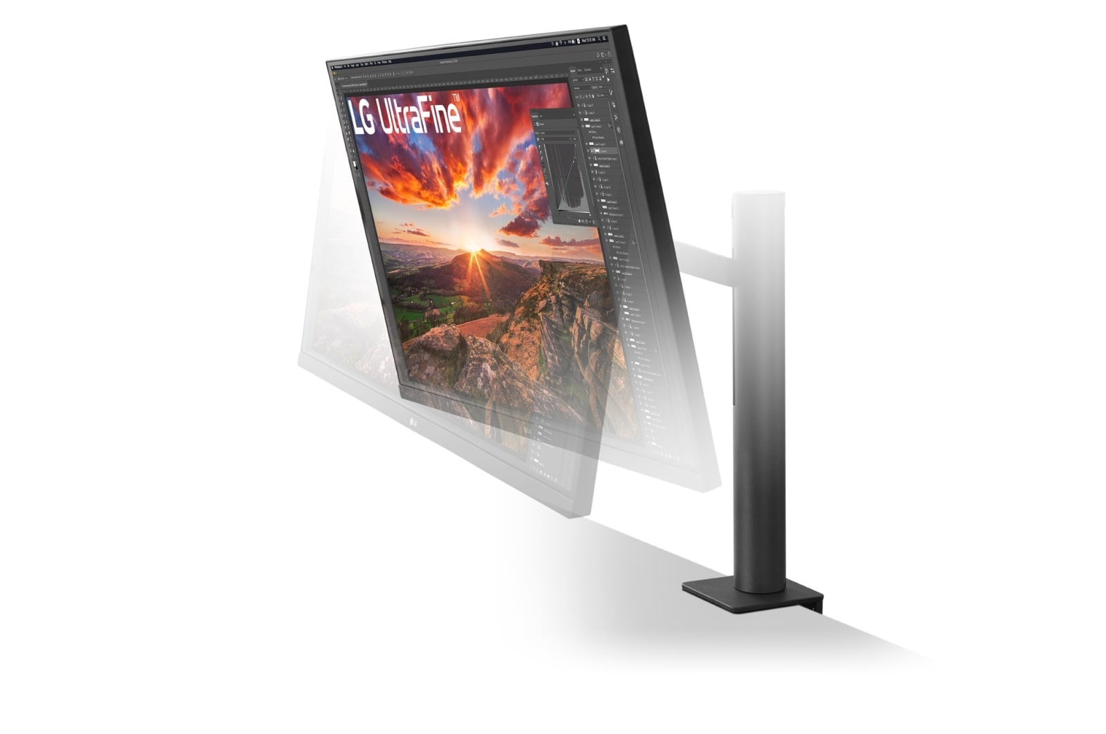 Monitor LG UltraFine wyświetlający górski krajobraz z zachodem słońca.