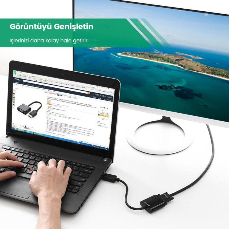 Bir dizüstü bilgisayar büyük bir monitöre bağlı. Biri klavyede yazıyor.