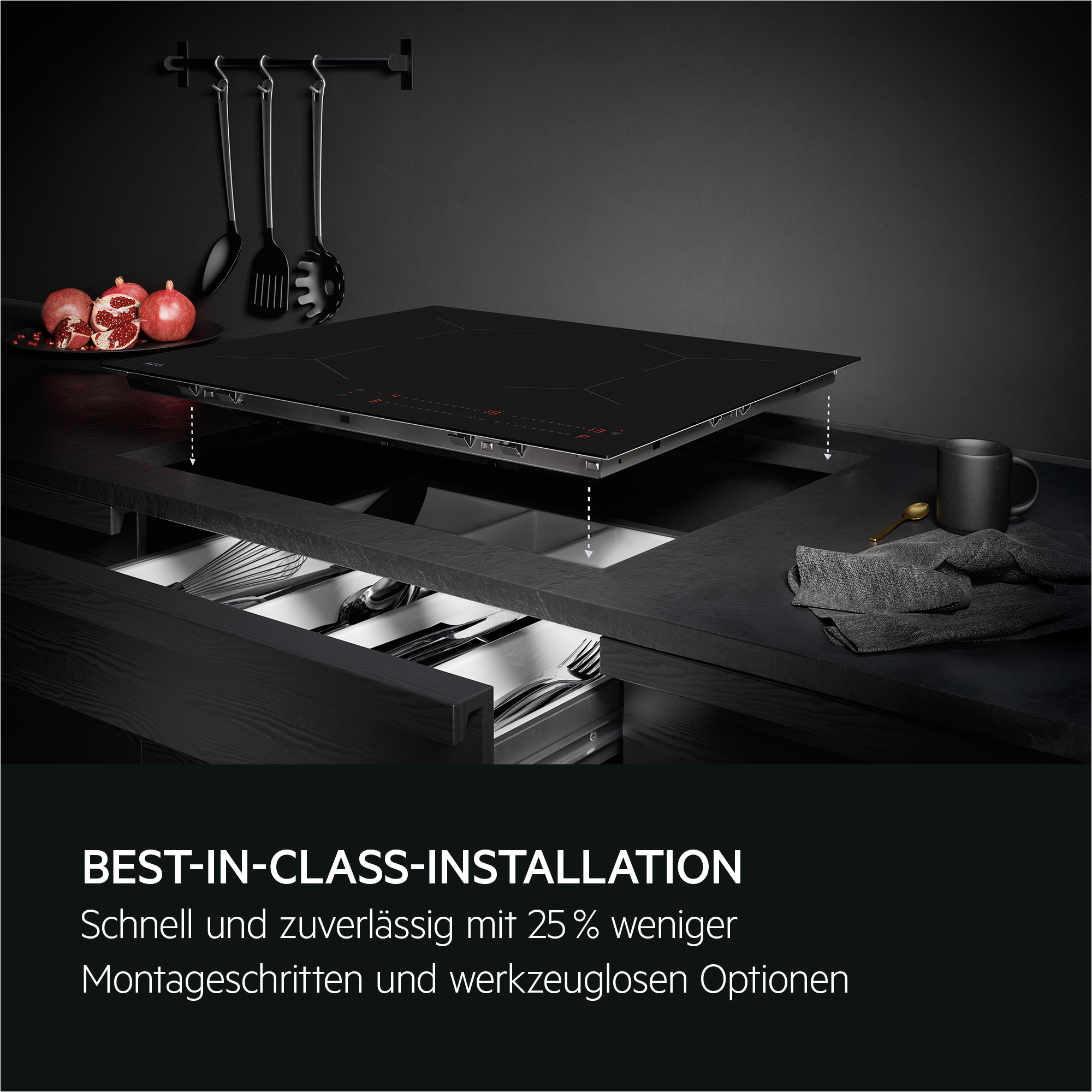 Schwarzes Kochfeld mit Besteckschublade und Küchenutensilien. Modernes Design.
