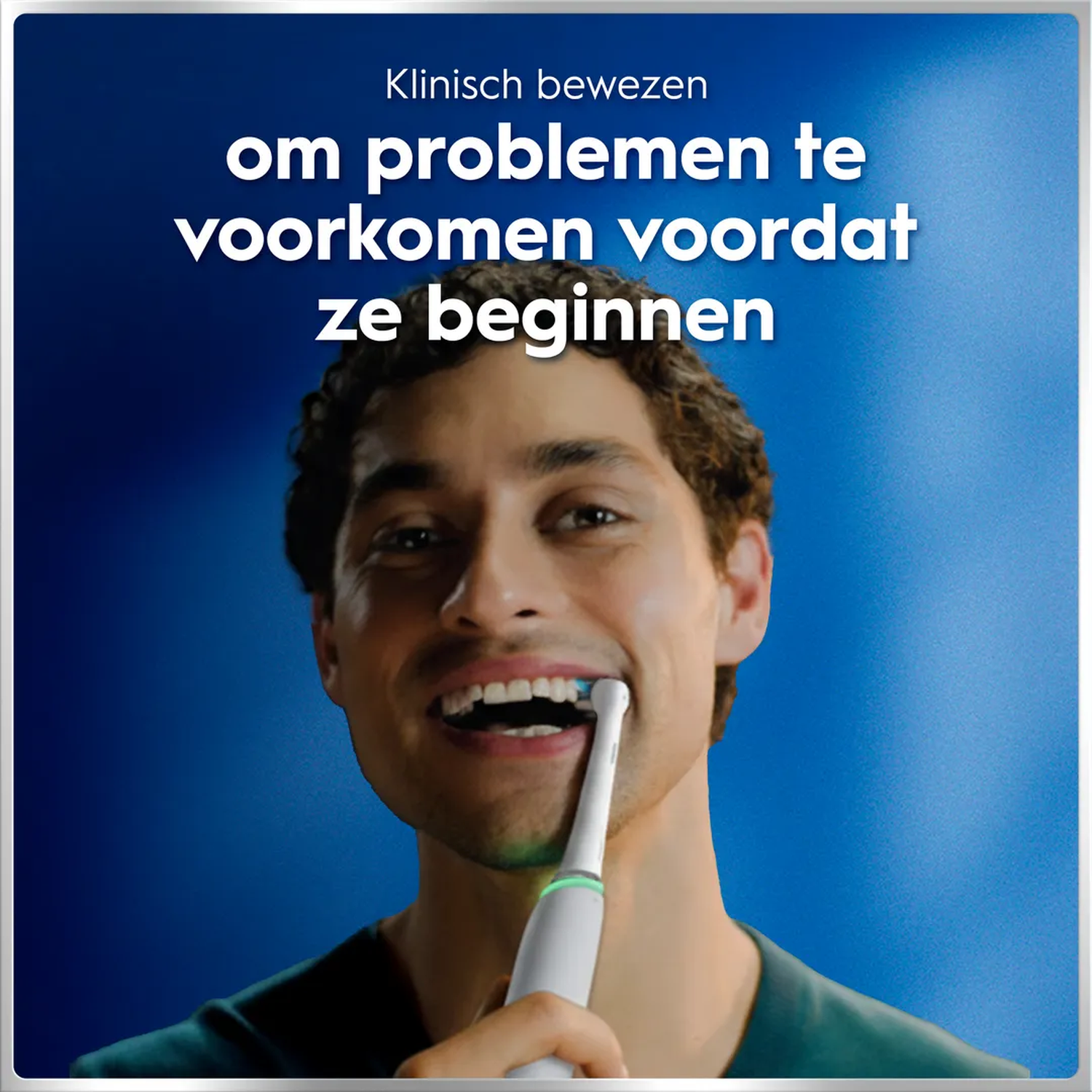 Man brushes teeth with an electric toothbrush.