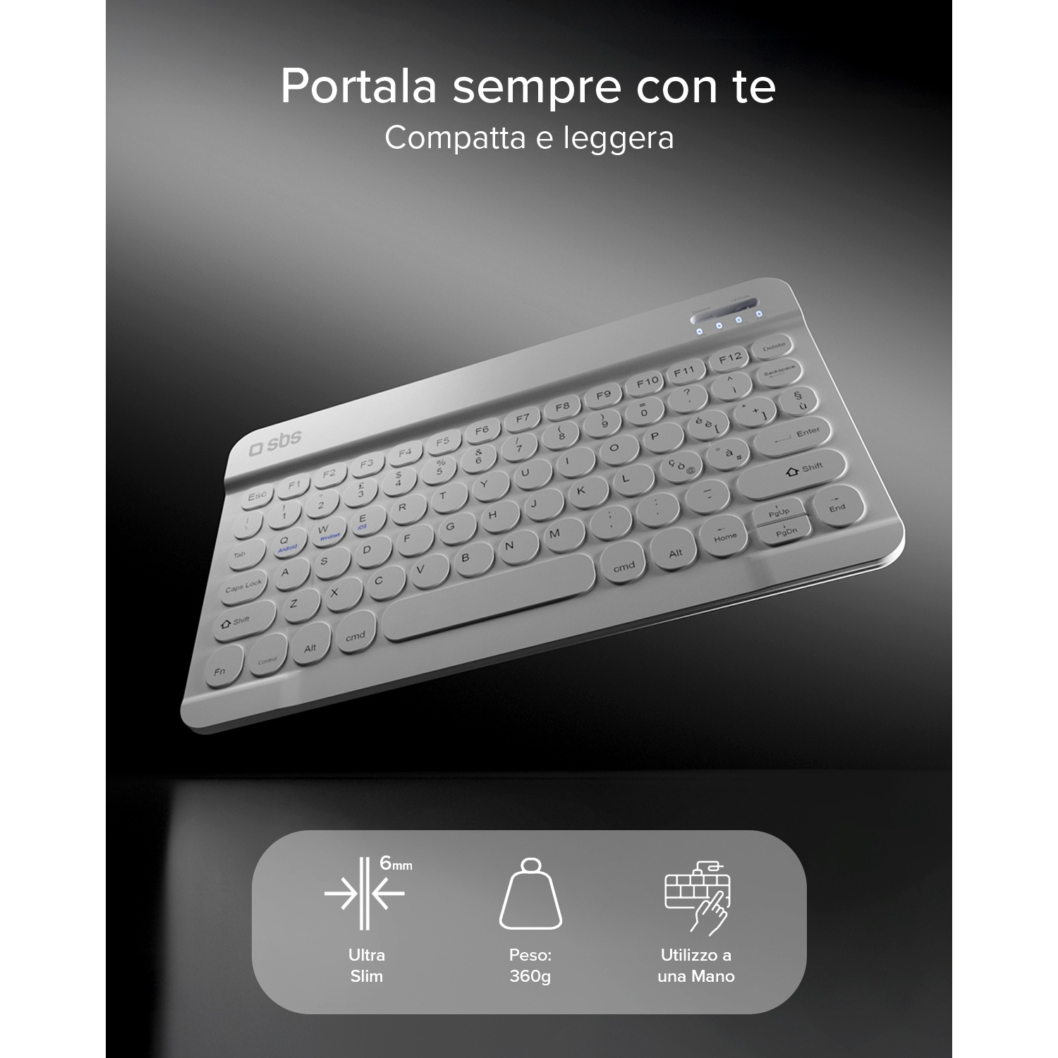 Tastiera SBS grigia con molti tasti e simboli su sfondo scuro.