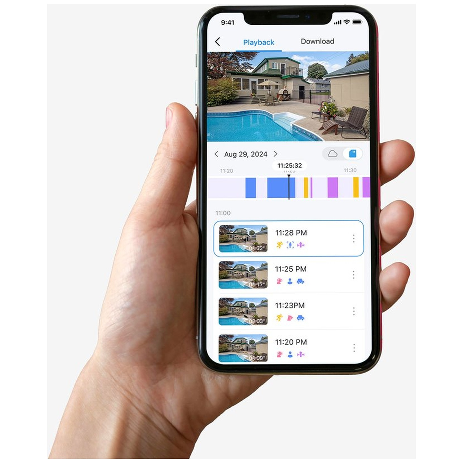 Hand holding smartphone with security app: reviewing a backyard pool area.