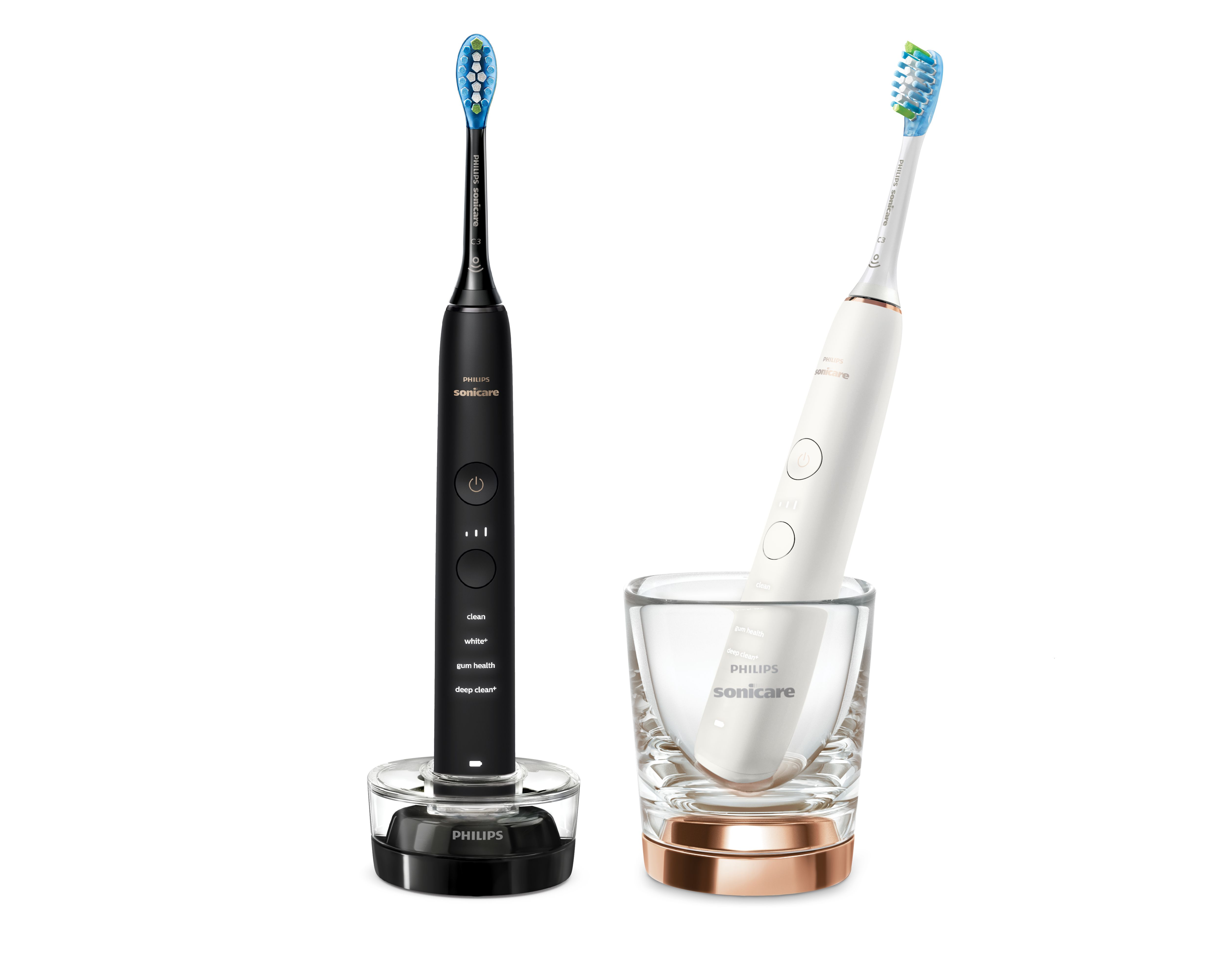 Dwa szczoteczki Philips Sonicare: czarna na ładowarce, biała w szklance.