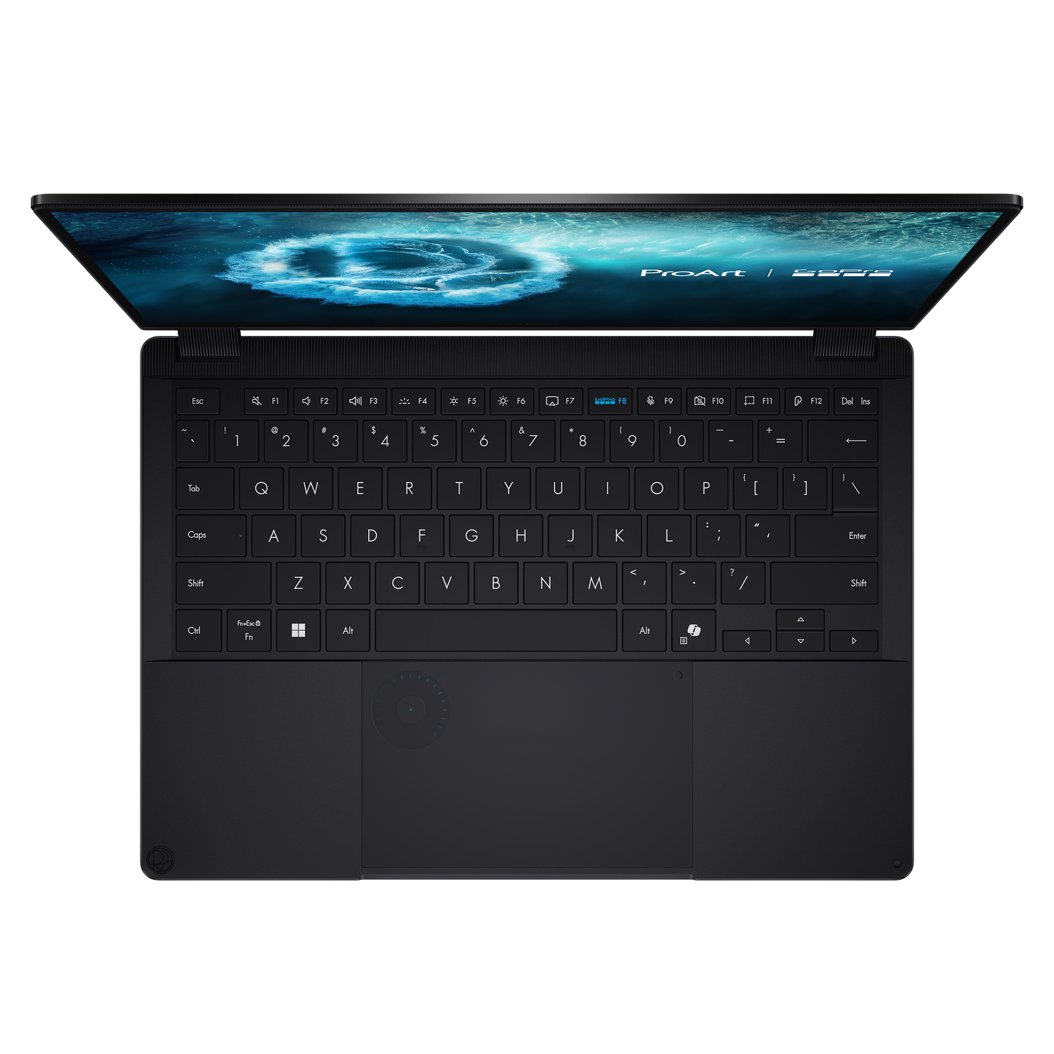 Un portátil ASUS ProArt negro está abierto, mostrando el teclado y la pantalla con arte azul abstracto.