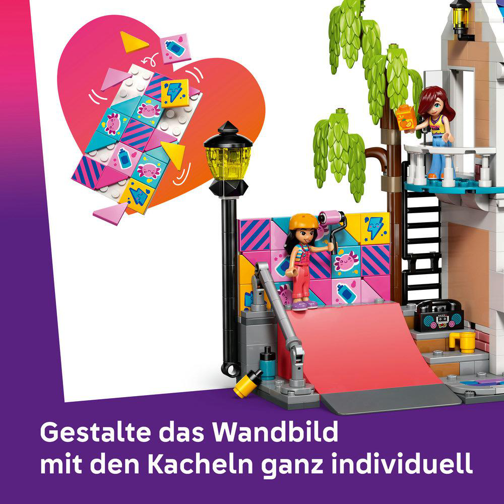 Lego-Figuren bauen eine bunte Wand mit Herz- und Tiermotiven.