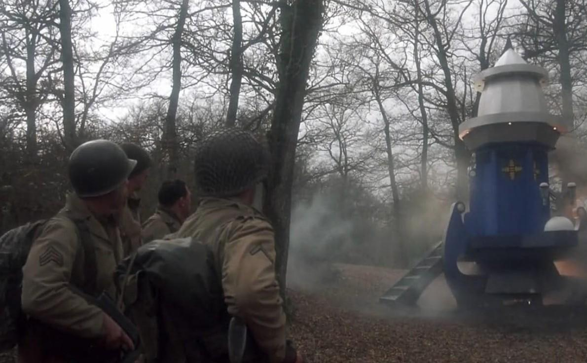 Soldaten stehen vor einer blauen und weißen Struktur im Wald.