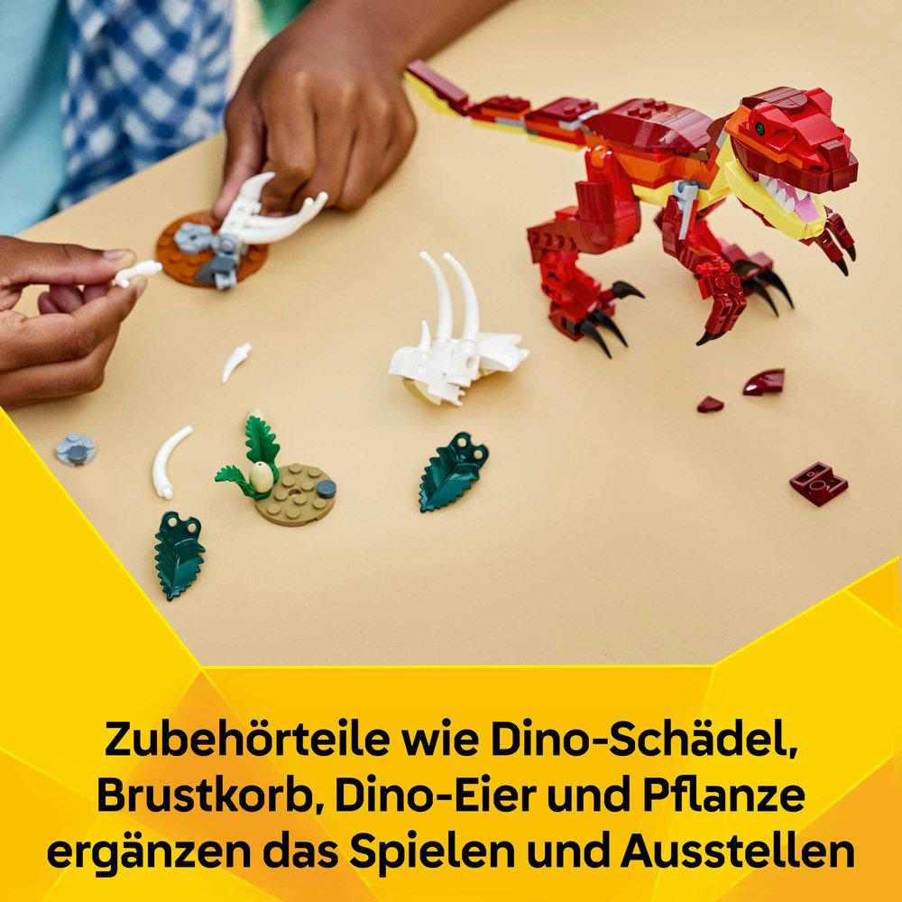 Ein Kind baut mit bunten Legosteinen einen roten Dinosaurier und Zubehör.