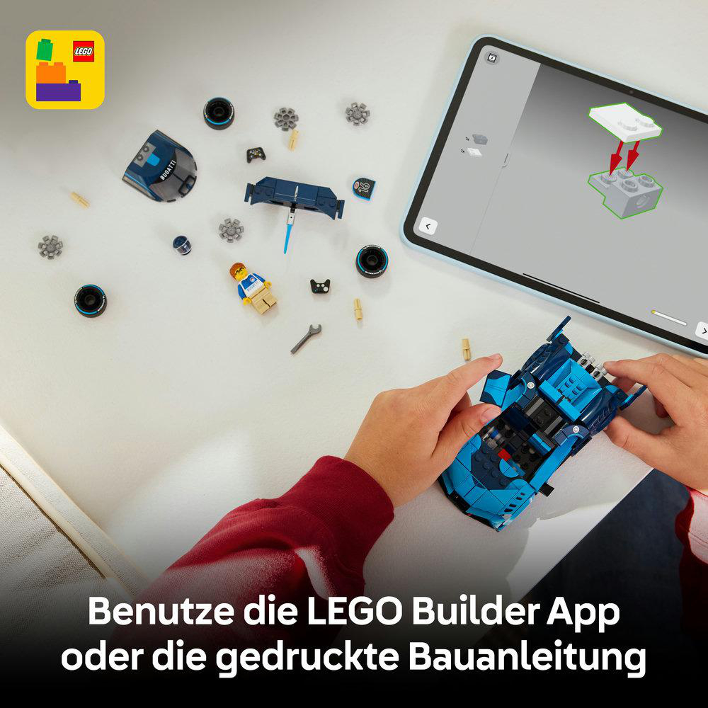 Ein Kind baut einen blauen LEGO Bugatti mit einer Bauanleitung auf einem Tablet.
